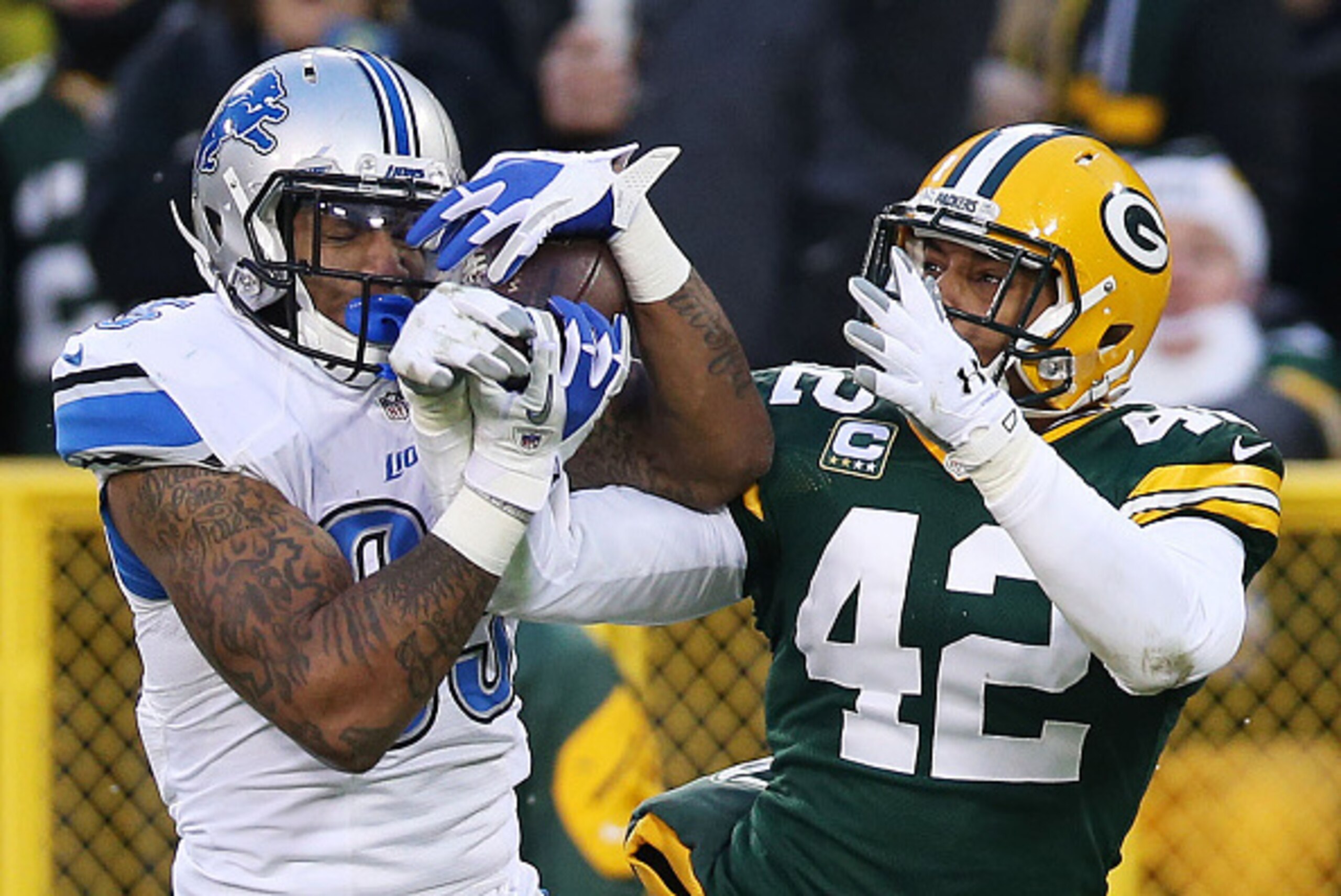 GREEN BAY, WI - DECEMBER 28:  Morgan Burnett #42 of the Green Bay Packers breaks up a pass intended  Eric Ebron #85 of the Detroit Lions in the second quarter at Lambeau Field on December 28, 2014 in Green Bay, Wisconsin.  (Photo by Chris Graythen/Getty I