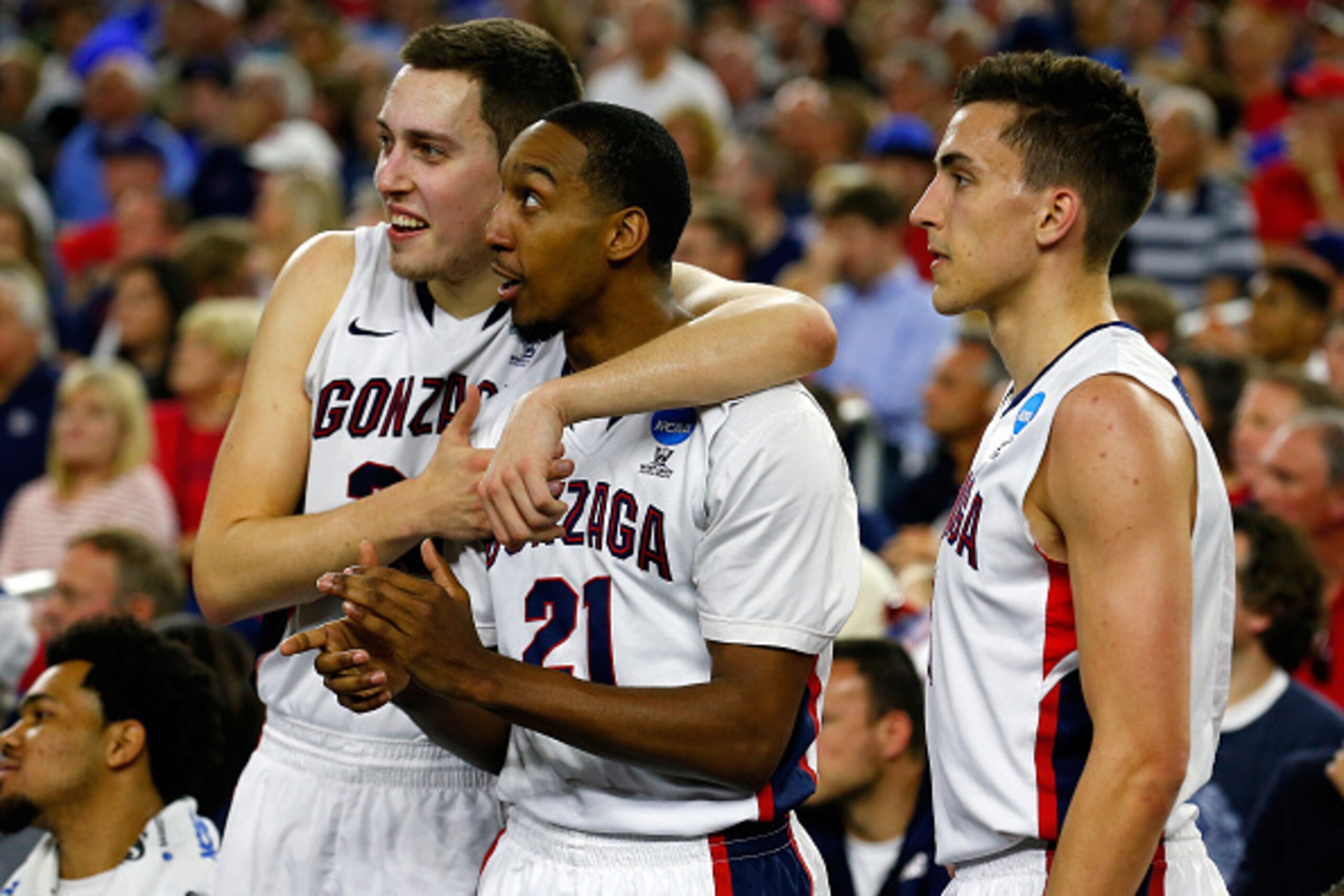 HOUSTON, TX - MARCH 27: Kyle Wiltjer #33, Eric McClellan #21, and Kyle Dranginis #3 of the Gonzaga Bulldogs look on from the bench against the UCLA Bruins during a South Regional Semifinal game of the 2015 NCAA Men's Basketball Tournament at NRG Stadium o