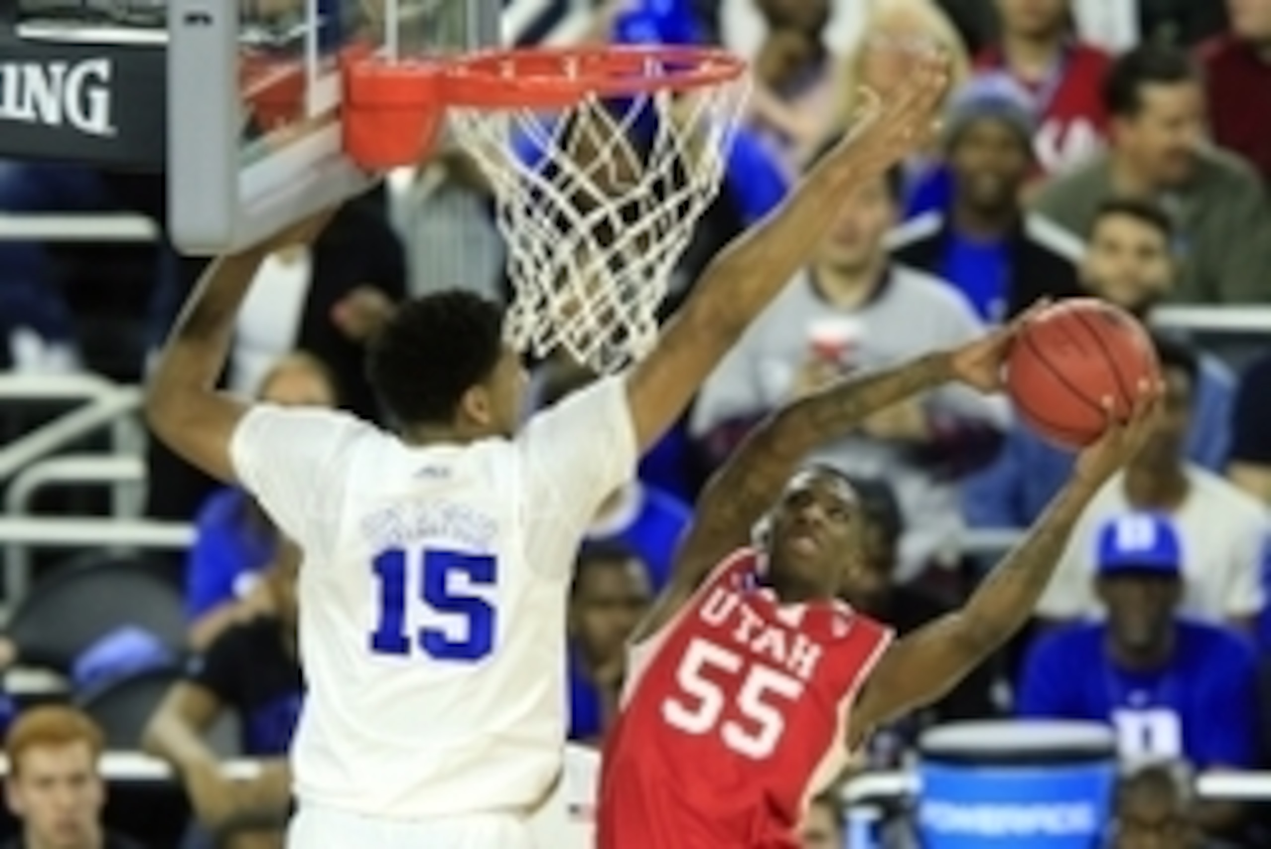 Mar 27, 2015; Houston, TX, USA; Utah Utes guard Delon Wright (55) shoots against Duke Blue Devils center Jahlil Okafor (15) during the first half in the semifinals of the south regional of the 2015 NCAA Tournament at Reliant Stadium. Mandatory Credit: Kev