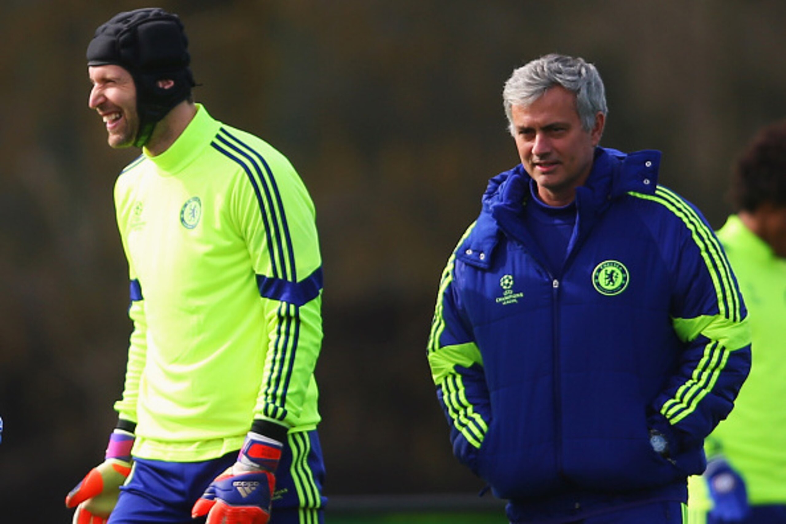 COBHAM, ENGLAND - MARCH 10:  Jose Mourinho manager of Chelsea (R) and goalkeeper Petr Cech (2R) smile during a Chelsea training session ahead of the UEFA Champions League Round of 16 second leg match against Paris Saint-Germain at Chelsea Training Ground 