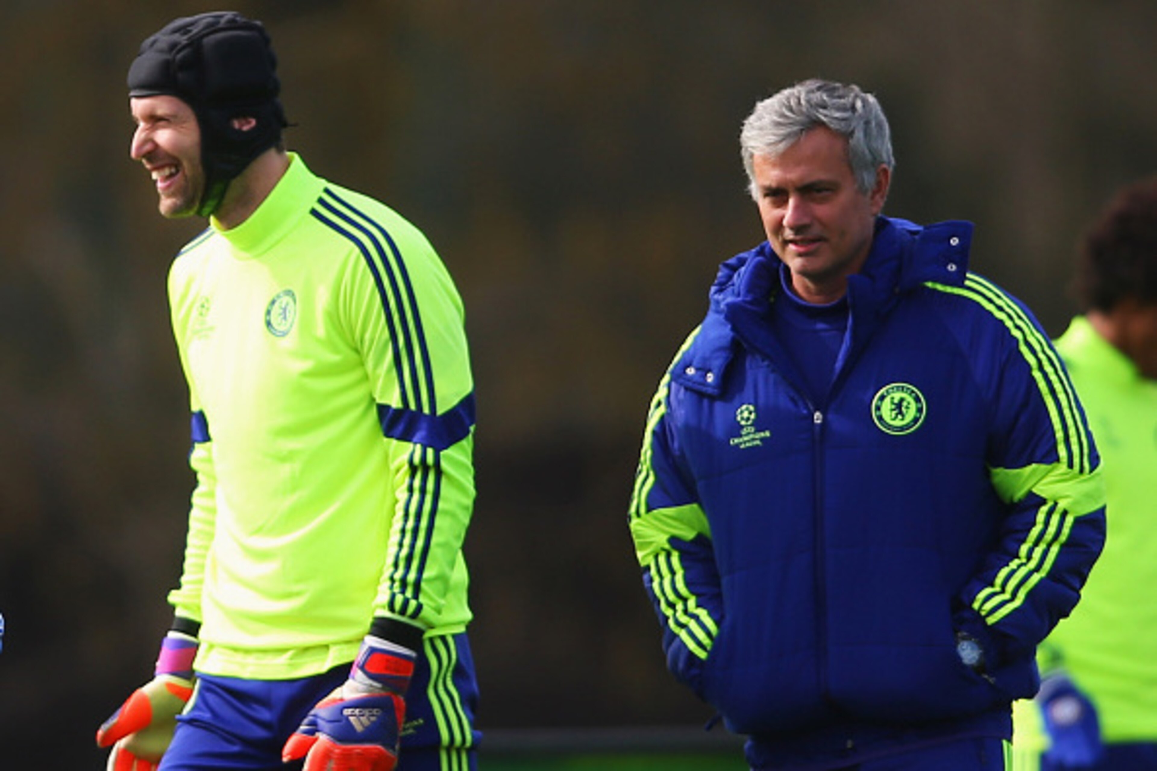 COBHAM, ENGLAND - MARCH 10:  Jose Mourinho manager of Chelsea (R) and goalkeeper Petr Cech (2R) smile during a Chelsea training session ahead of the UEFA Champions League Round of 16 second leg match against Paris Saint-Germain at Chelsea Training Ground 