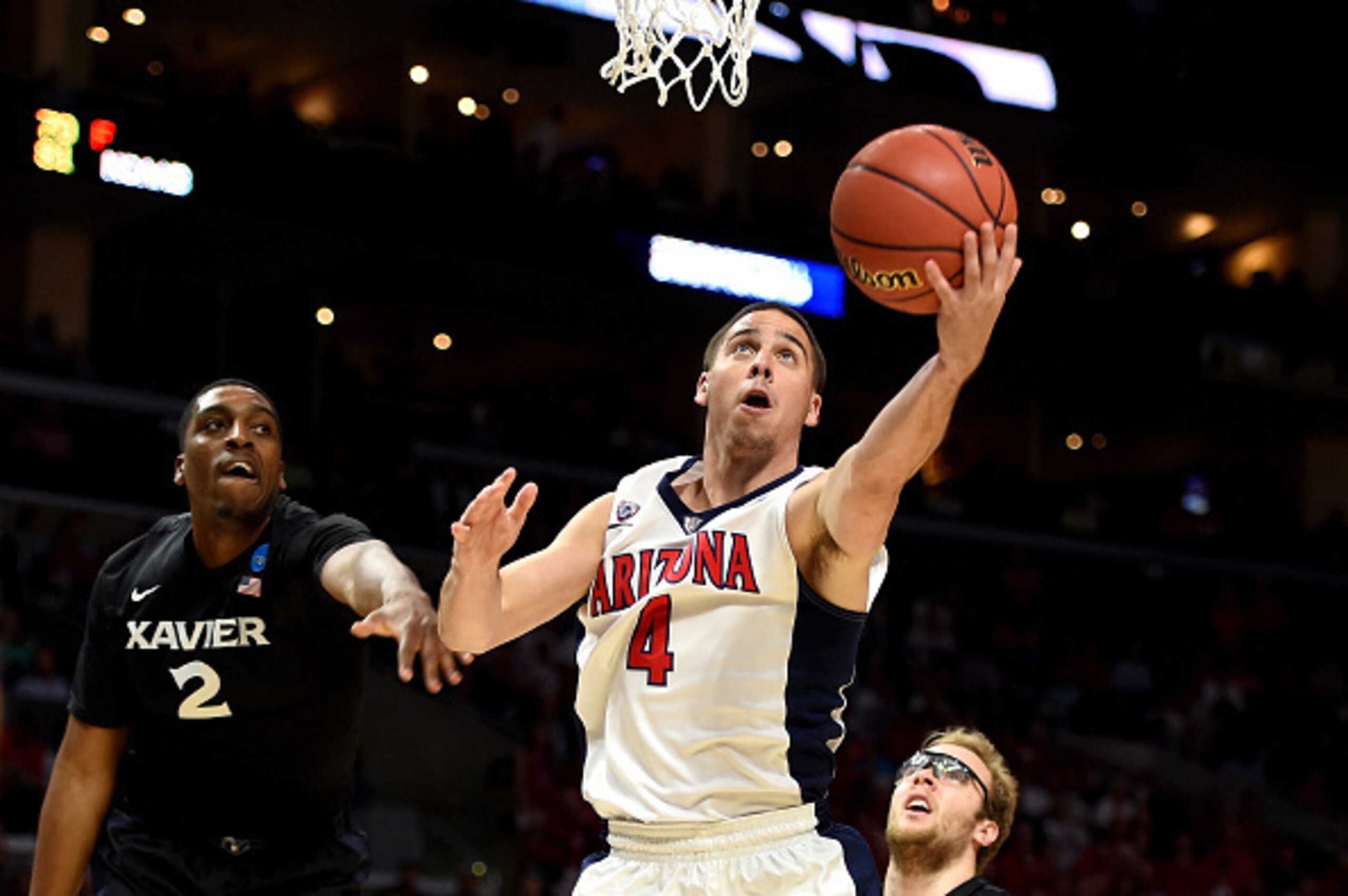 LOS ANGELES, CA - MARCH 26:  T.J. McConnell #4 of the Arizona Wildcats goes up for a shot against James Farr #2 of the Xavier Musketeers in the first half during the West Regional Semifinal of the 2015 NCAA Men's Basketball Tournament at Staples Center on
