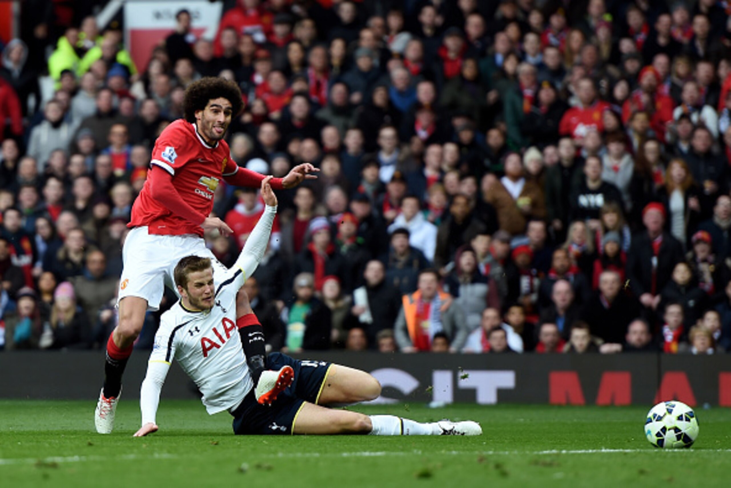 MANCHESTER, ENGLAND - MARCH 15:  Marouane Fellaini of Manchester United shoots past Eric Dier of Spurs to score the opening goal during the Barclays Premier League match between Manchester United and Tottenham Hotspur at Old Trafford on March 15, 2015 in 