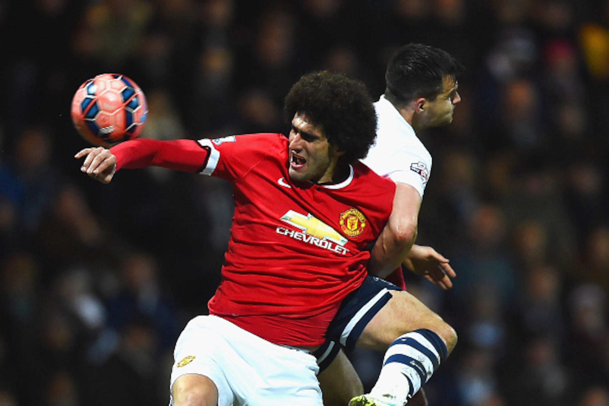 PRESTON, ENGLAND - FEBRUARY 16:  Marouane Fellaini of Manchester United and Bailey Wright of Preston North End compete for the ball during the FA Cup Fifth round match between Preston North End and Manchester United at Deepdale on February 16, 2015 in Pre