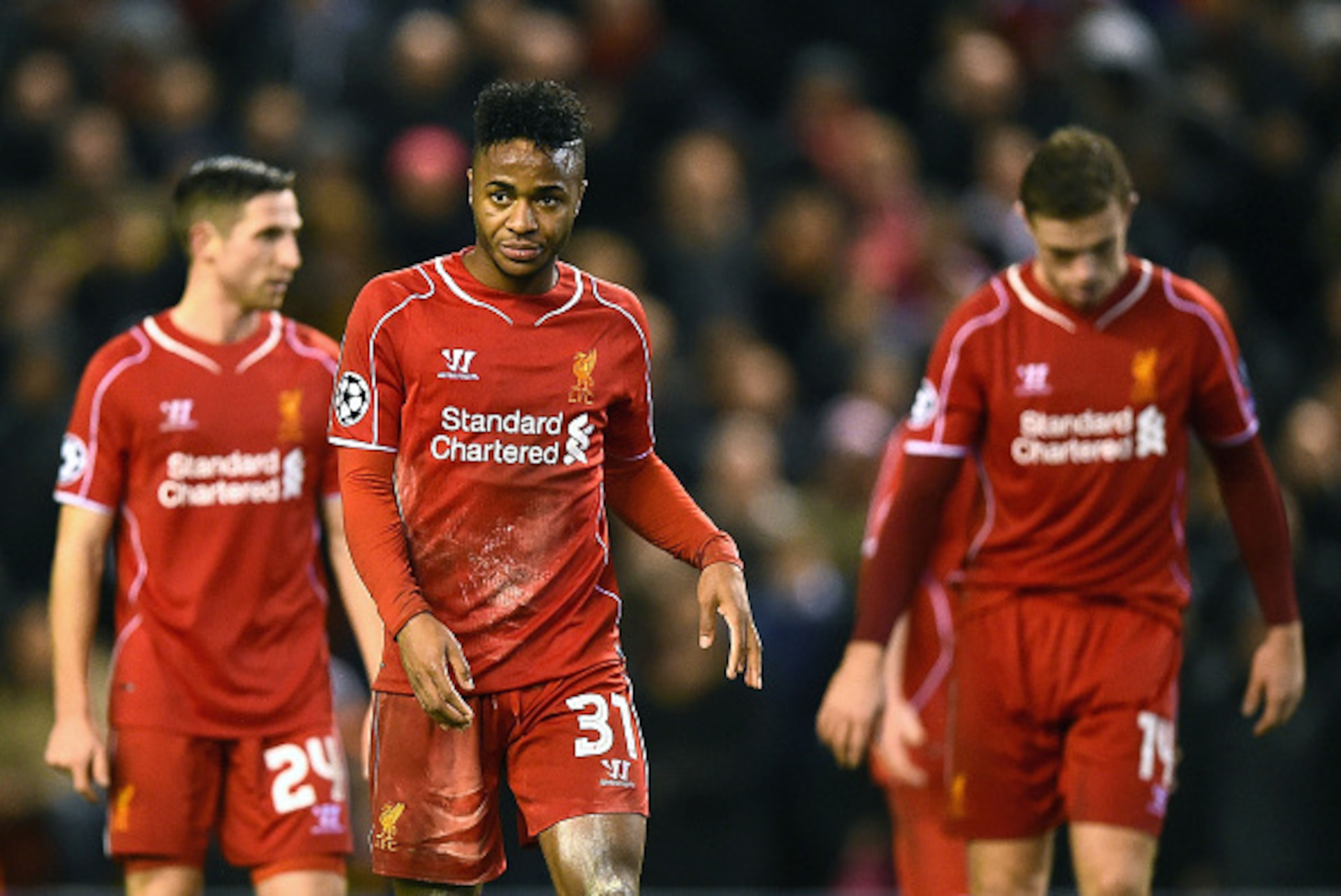 LIVERPOOL, ENGLAND - DECEMBER 09:  A dejected Raheem Sterling #31 of Liverpool and teammates walk off the pitch following their team's 1-1 draw and exit from the competition during the UEFA Champions League group B match between Liverpool and FC Basel 189
