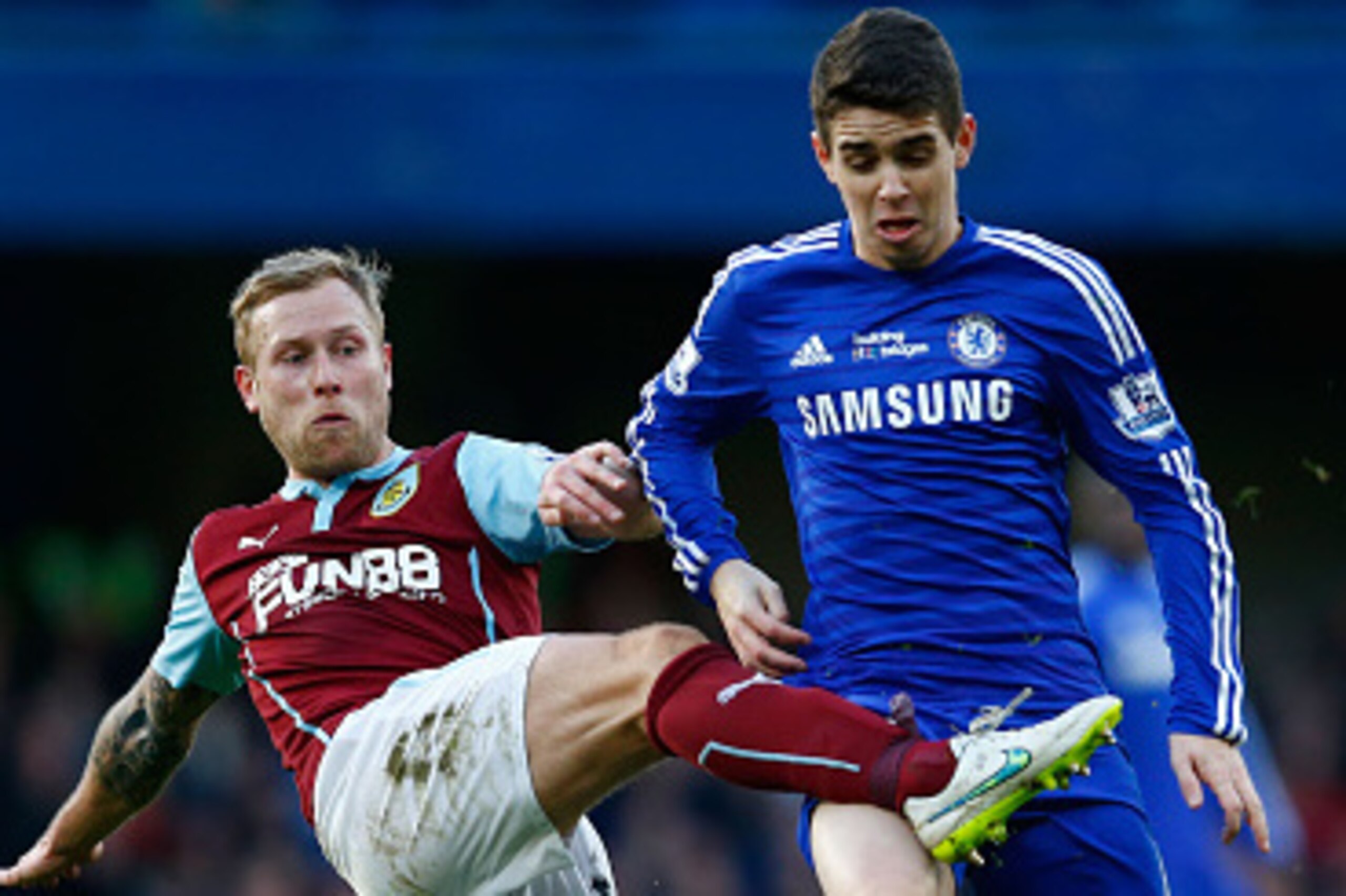 LONDON, ENGLAND - FEBRUARY 21:  Scott Arfield of Burnley tackles Oscar of Chelsea during the Barclays Premier League match between Chelsea and Burnley at Stamford Bridge on February 21, 2015 in London, England.  (Photo by Julian Finney/Getty Images)
