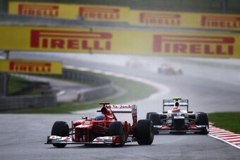 KUALA LUMPUR, MALAYSIA - MARCH 25:  Fernando Alonso of Spain and Ferrari holds off the challenge of Sergio Perez of Mexico and Sauber F1 as he drives on his way to winning the Malaysian Formula One Grand Prix at the Sepang Circuit on March 25, 2012 in Kua