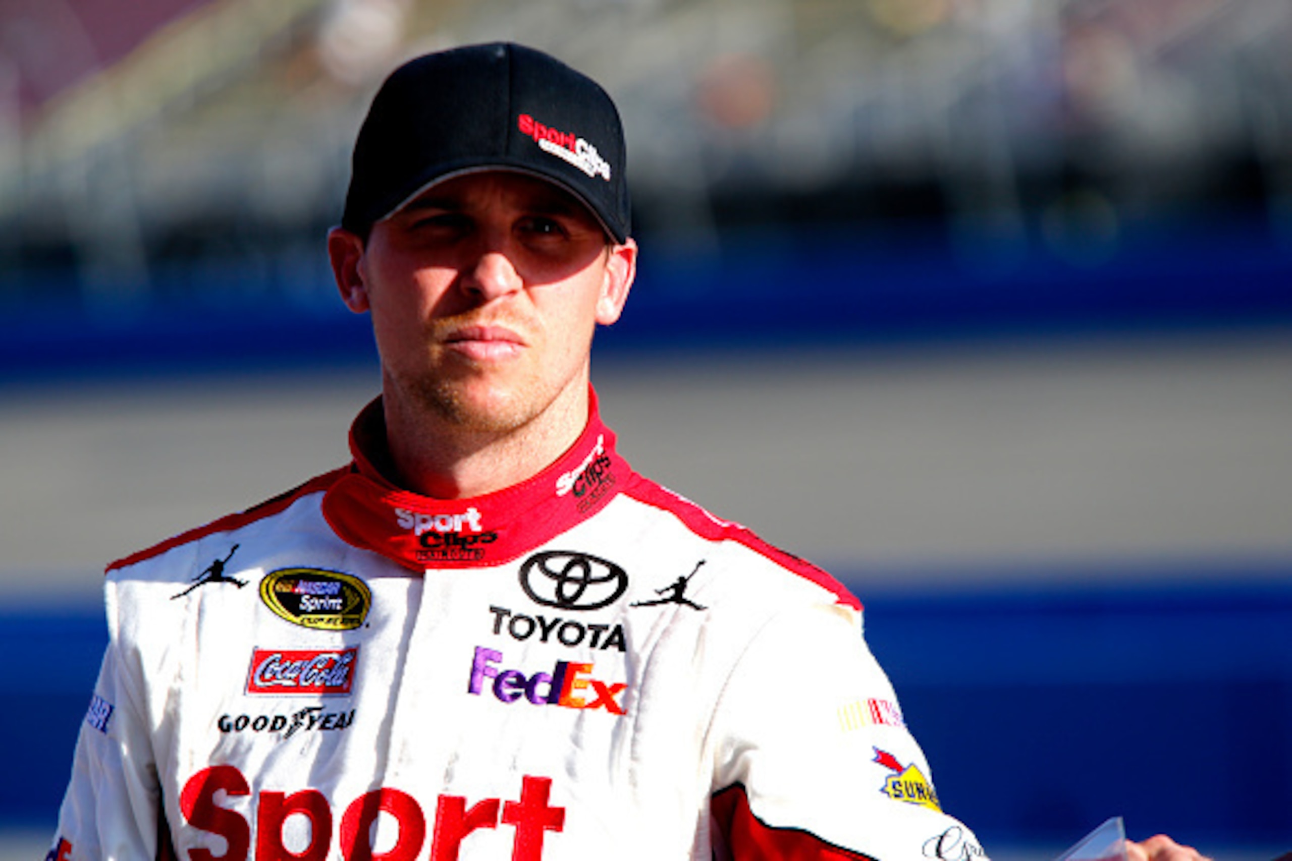 FONTANA, CA - MARCH 20:  Denny Hamlin, driver of the #11 Sport Clips Toyota, stands on the grid during qualifying for the NASCAR Sprint Cup Series Auto Club 400 at Auto Club Speedway on March 20, 2015 in Fontana, California.  (Photo by Jerry Markland/Gett