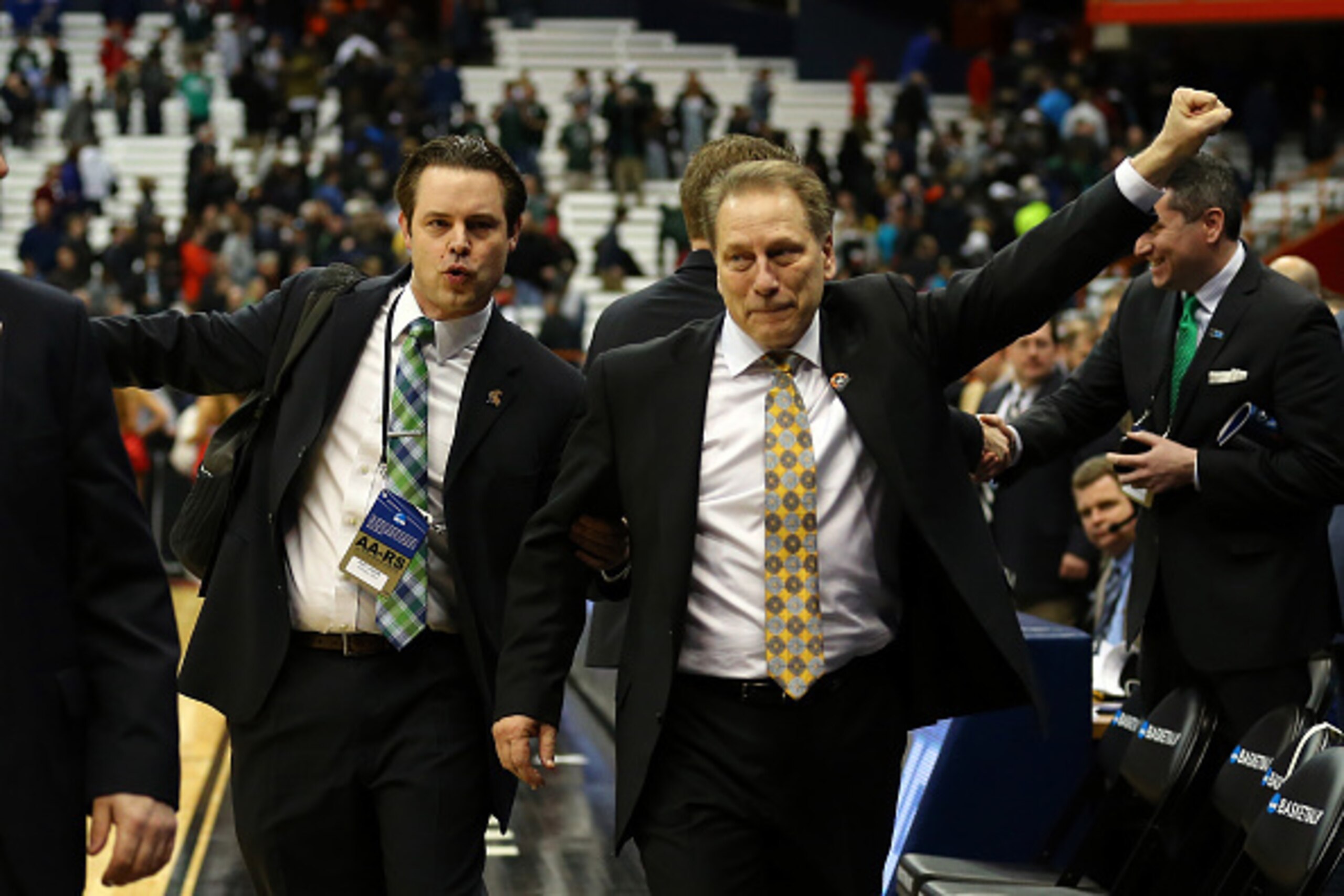 SYRACUSE, NY - MARCH 27:  Head coach Tom Izzo of the Michigan State Spartans celebrates with Matt Larson after defeating the Oklahoma Sooners 62 to 58 during the East Regional Semifinal of the 2015 NCAA Men's Basketball Tournament at the Carrier Dome on M