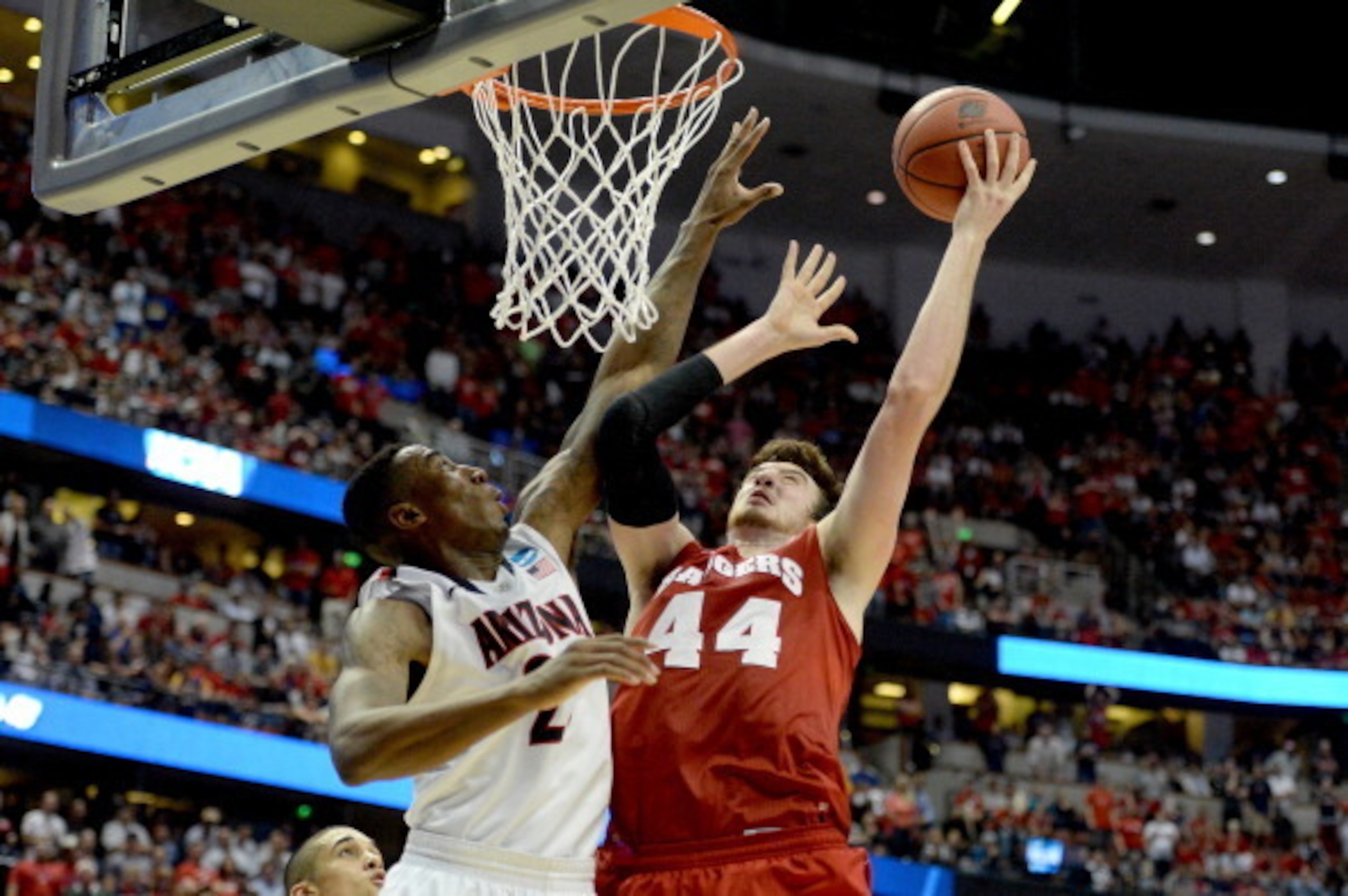 ANAHEIM, CA - MARCH 29:  Frank Kaminsky #44 of the Wisconsin Badgers goes up for a shot over Rondae Hollis-Jefferson #23 of the Arizona Wildcats in overtime during the West Regional Final of the 2014 NCAA Men's Basketball Tournament at the Honda Center on