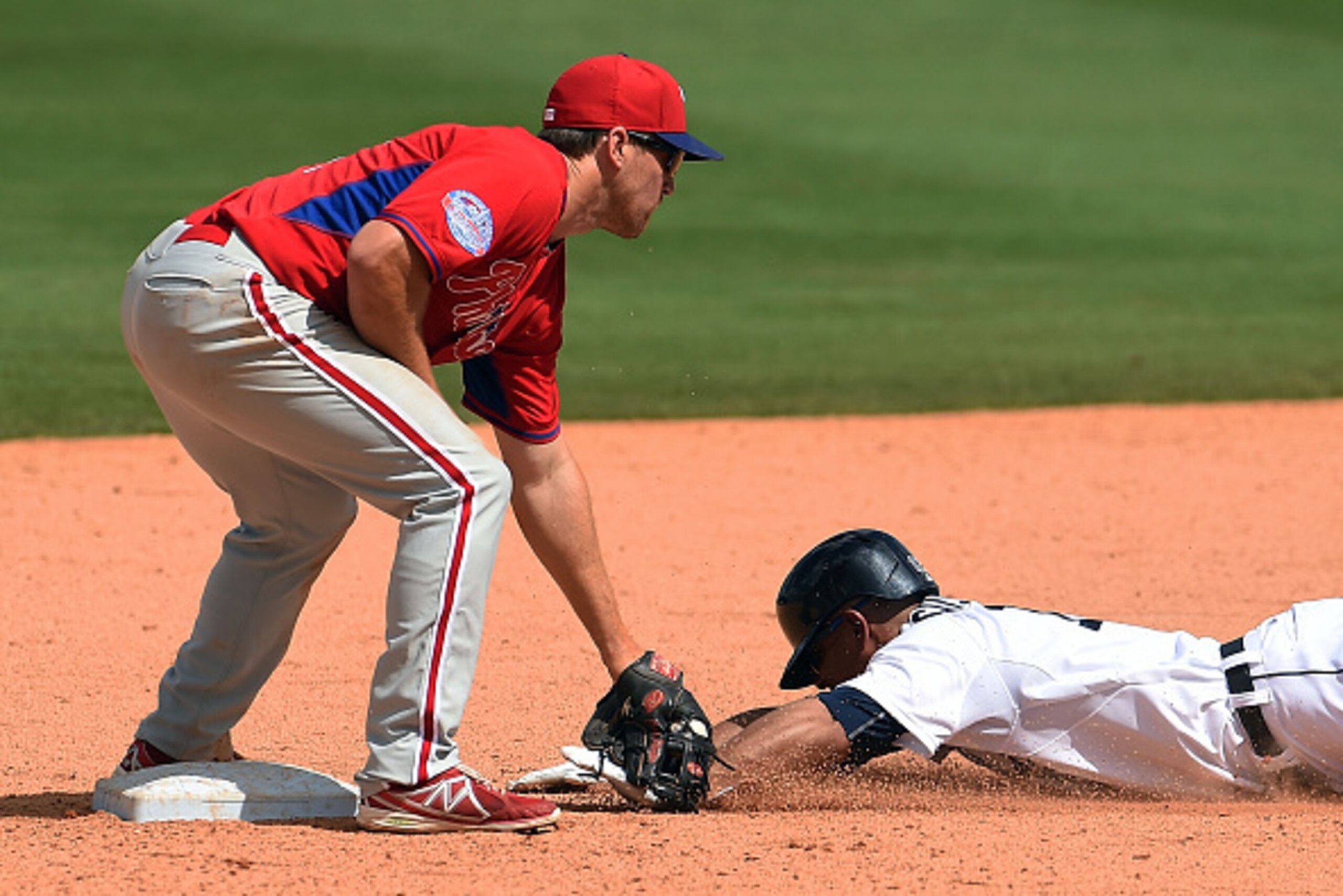 LAKELAND, FL - MARCH 14:  Anthony Gose #12 of the Detroit Tigers is tagged out at second base by Cord Phelps #71 of the Philadelphia Phillies during the sixth inning of a spring training game at Joker Marchant Stadium on March 14, 2015 in Lakeland, Florid