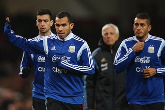 LONDON, ENGLAND - NOVEMBER 12:  Carlos Tevez of Argentina waves to fans as he warms up prior to playing in the second half of the International Friendly between Argentina and Croatia at Boleyn Ground on November 12, 2014 in London, England.  (Photo by Bry