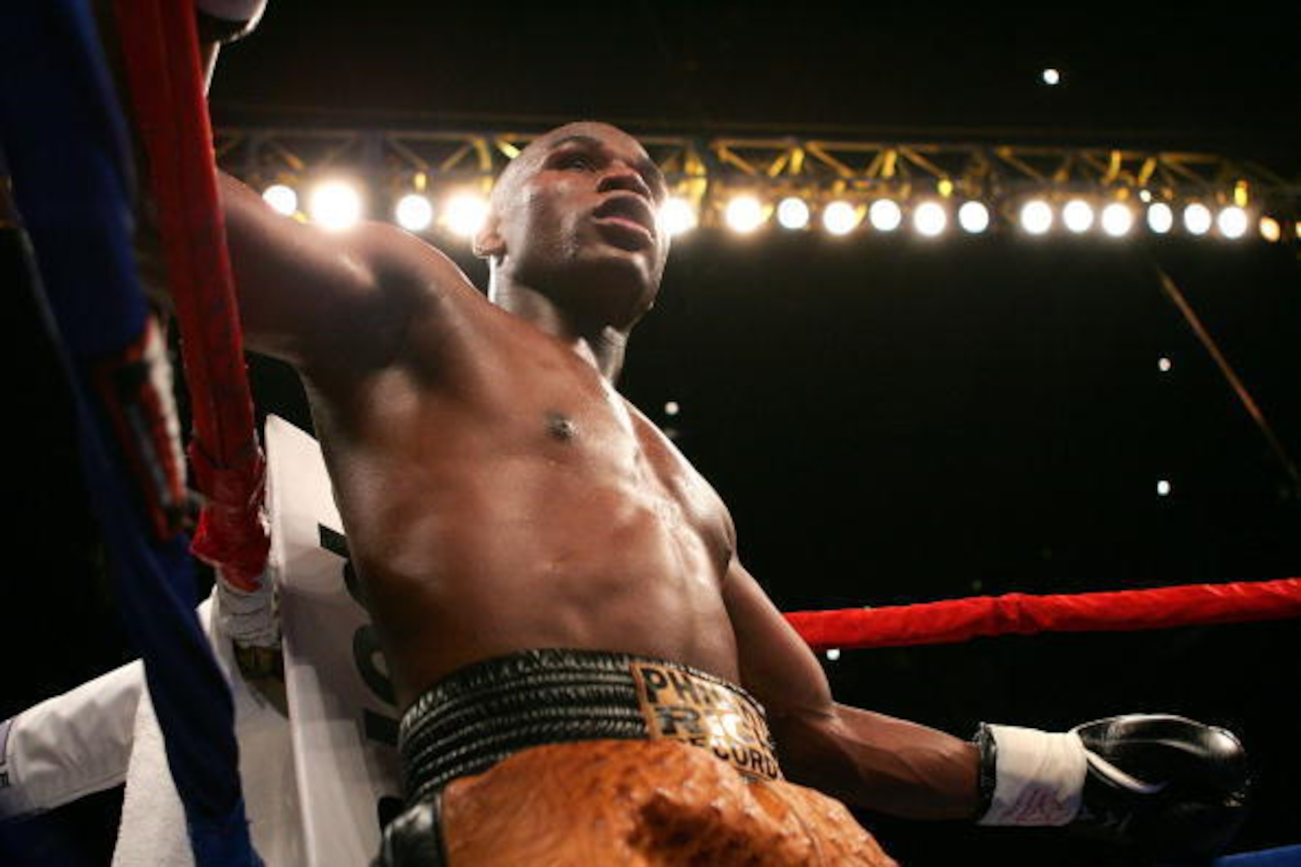 PORTLAND, OR - NOVEMBER 19:  Floyd Mayweather waits in a corner after knocking down Sharmba Mitchell during their welterweight fight at the Rose Garden on November 19, 2005 in Portland, Oregon. Mayweather defeated Mitchell in a sixth round TKO.  (Photo by