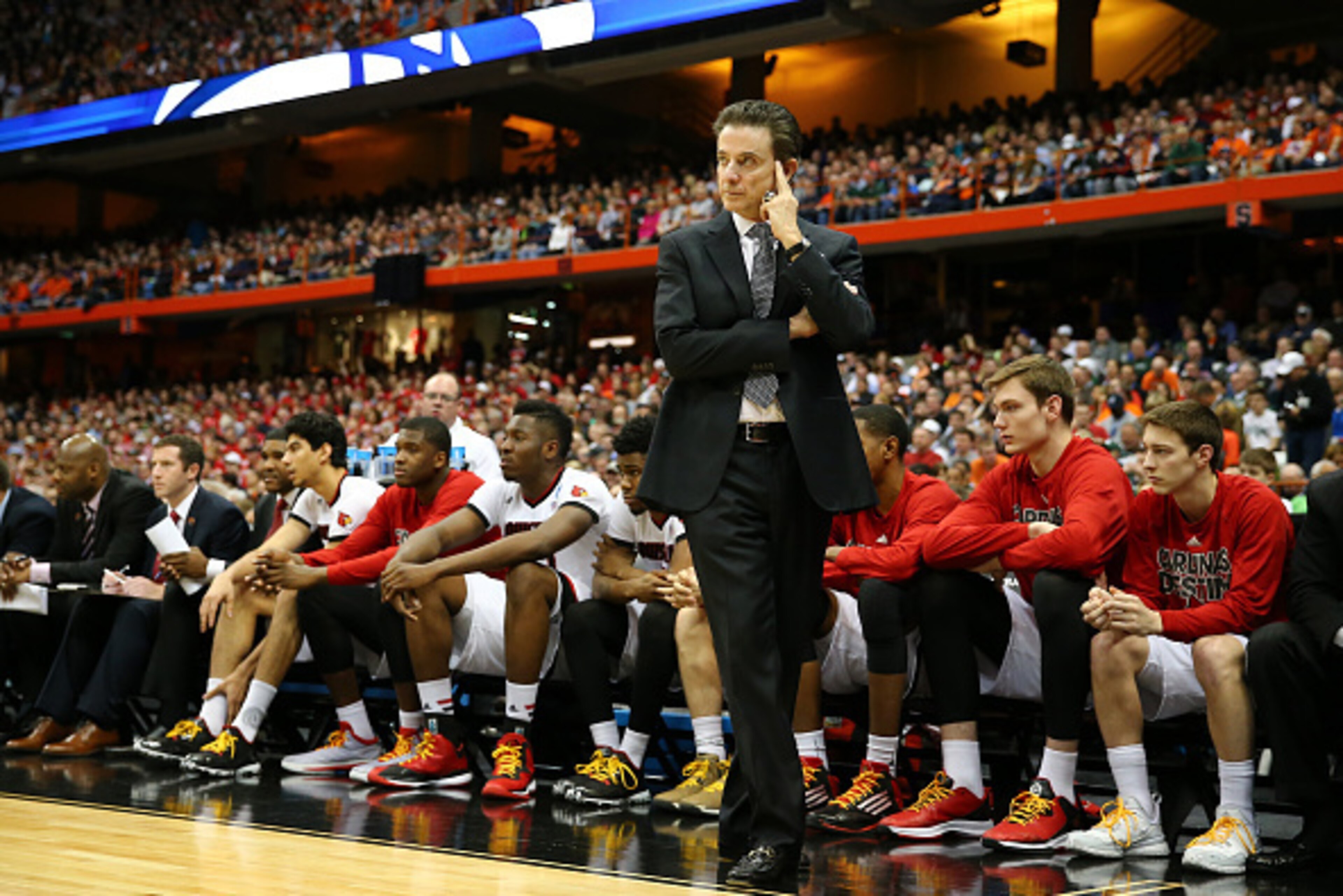 SYRACUSE, NY - MARCH 27:  Head coach Rick Pitino of the Louisville Cardinals reacts in the first half of the game anc during the East Regional Semifinal of the 2015 NCAA Men's Basketball Tournament at the Carrier Dome on March 27, 2015 in Syracuse, New Yo