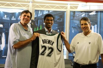 MINNEAPOLIS - JUNE 29:  Minnesota Timberwolves 2007 NBA Draft Pick Corey Brewer smiles as his new jersey is held by Vice President of Basketball Operations Kevin McHale (L) and Head Coach Randy Wittmann (R) at the start of the introductory press conferenc