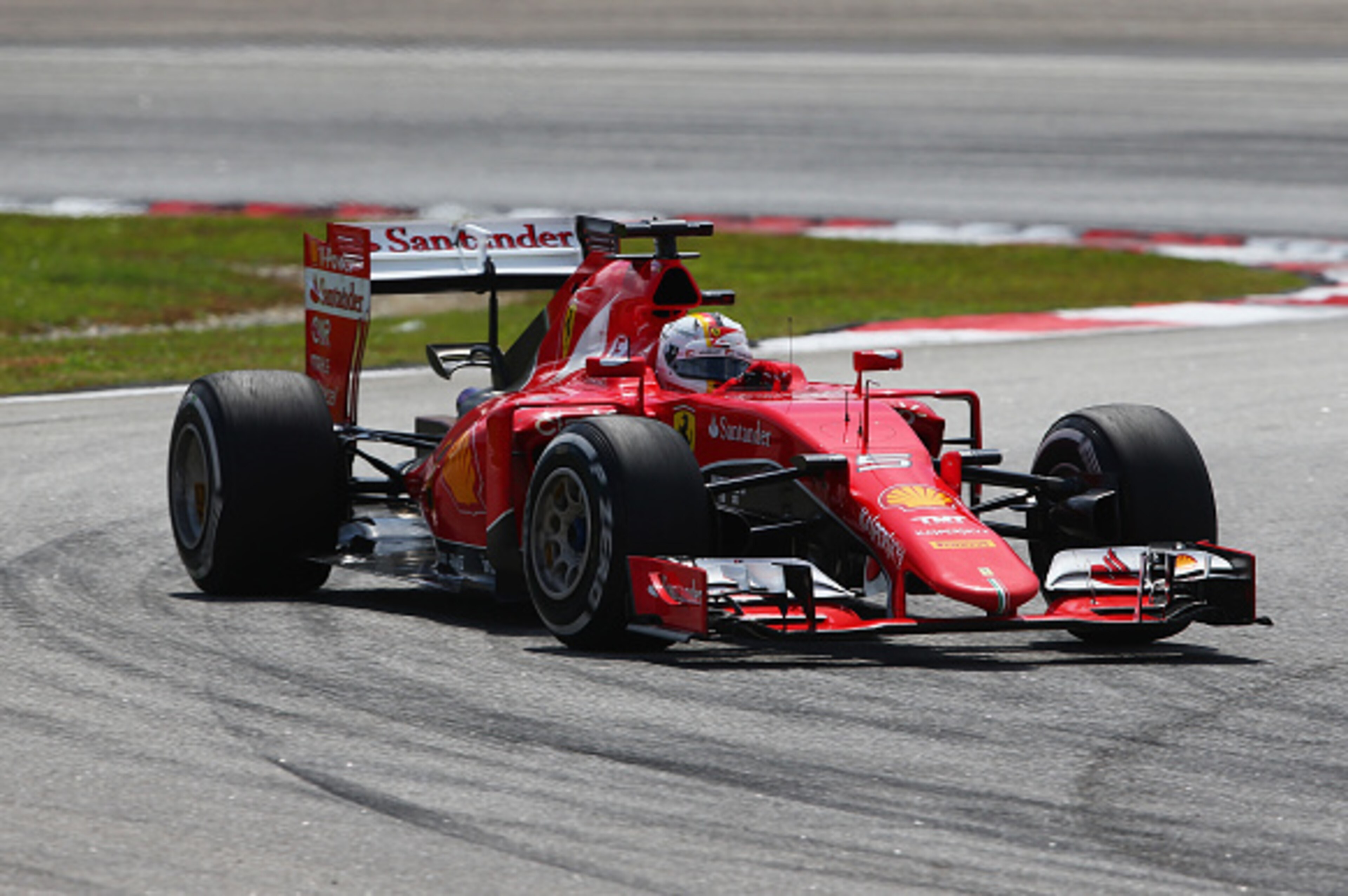 KUALA LUMPUR, MALAYSIA - MARCH 29: Sebastian Vettel of Germany and Ferrari leads during the Malaysia Formula One Grand Prix at Sepang Circuit on March 29, 2015 in Kuala Lumpur, Malaysia.  (Photo by Mark Thompson/Getty Images)