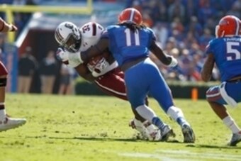 Nov 15, 2014; Gainesville, FL, USA; Florida Gators linebacker Neiron Ball (11) tackles South Carolina Gamecocks running back David Williams (33) during the first quarter at Ben Hill Griffin Stadium. Mandatory Credit: Kim Klement-USA TODAY Sports