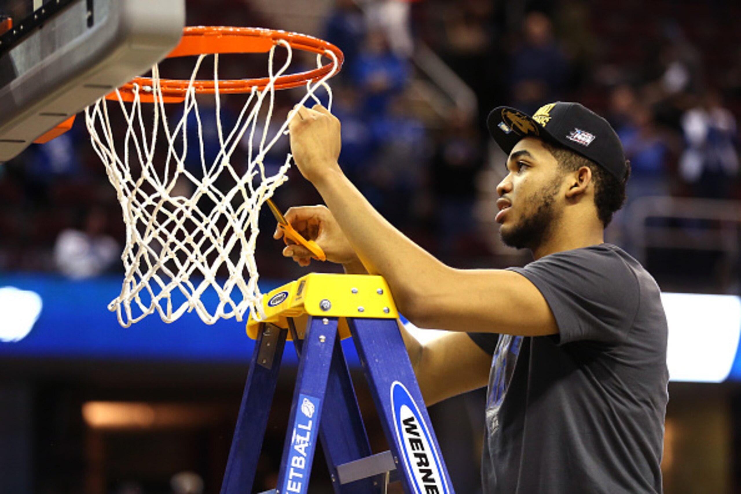 CLEVELAND, OH - MARCH 28: Karl-Anthony Towns #12 of the Kentucky Wildcats cuts down the net after defeating the Notre Dame Fighting Irish during the Midwest Regional Final of the 2015 NCAA Men's Basketball tournament at Quicken Loans Arena on March 28, 20