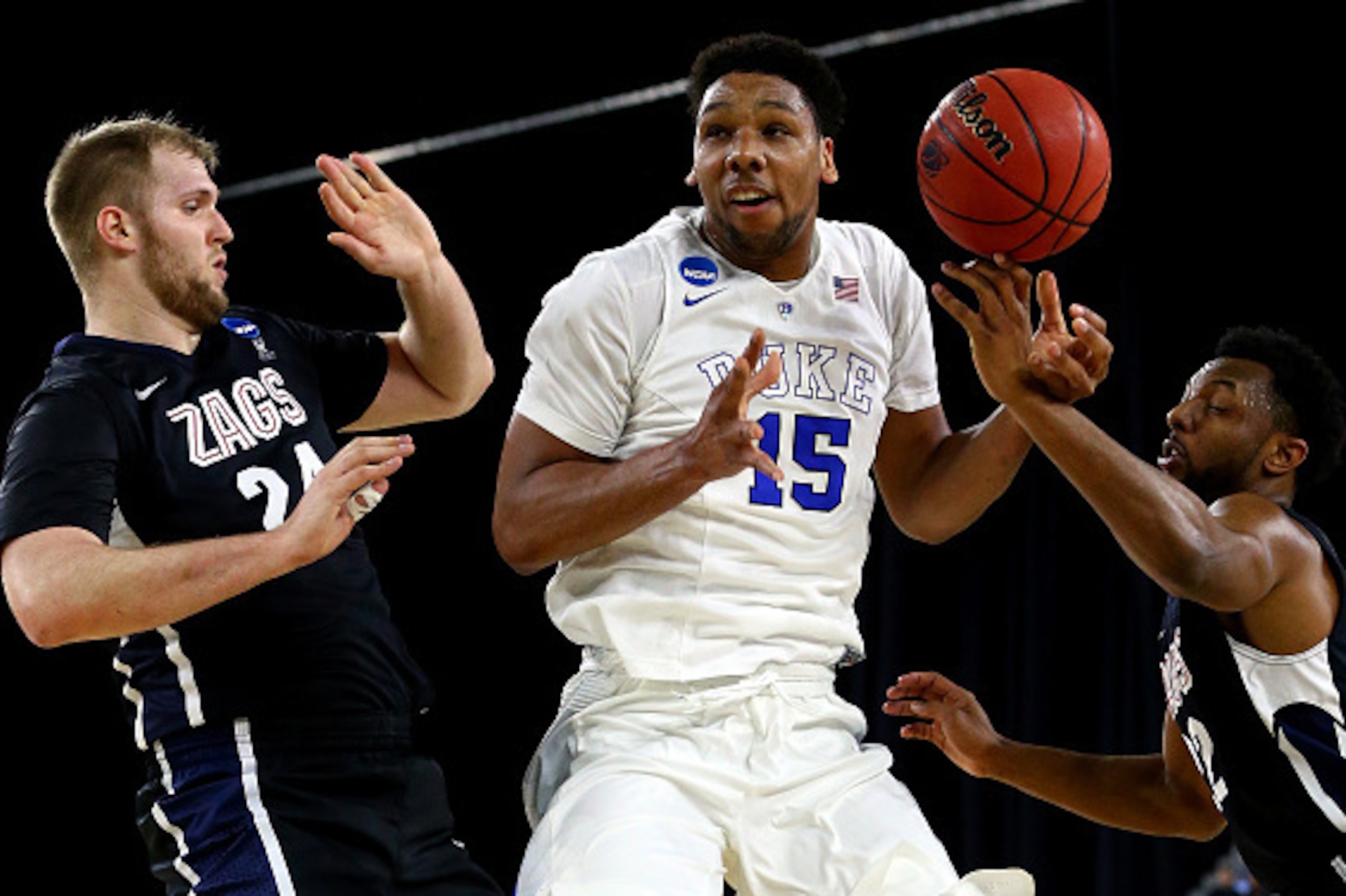 HOUSTON, TX - MARCH 29: Jahlil Okafor #15 of the Duke Blue Devils loses control of the ball as Przemek Karnowski #24 and Byron Wesley #22 of the Gonzaga Bulldogs defend in the first half during the South Regional Final of the 2015 NCAA Men's Basketball To