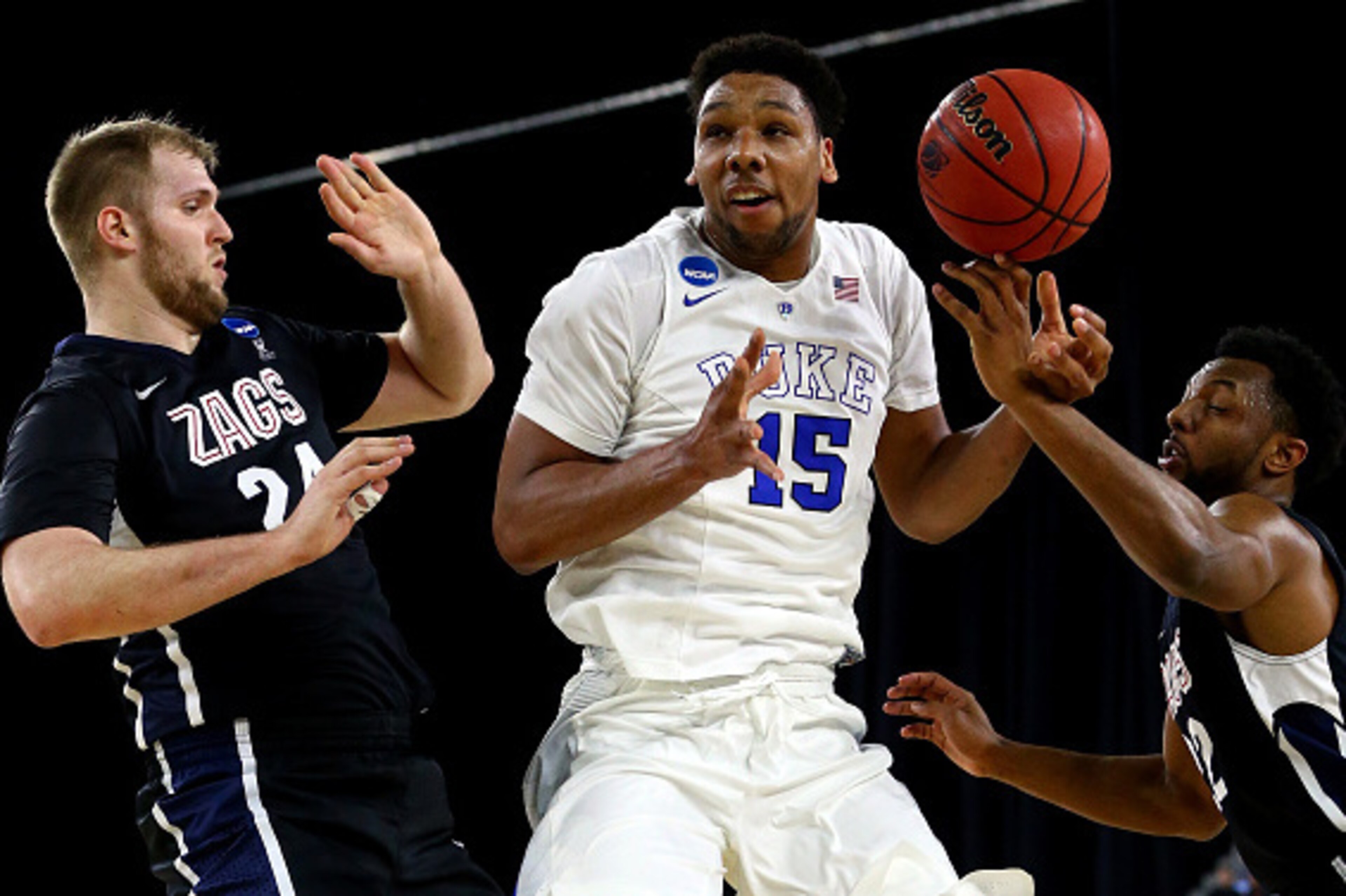 HOUSTON, TX - MARCH 29: Jahlil Okafor #15 of the Duke Blue Devils loses control of the ball as Przemek Karnowski #24 and Byron Wesley #22 of the Gonzaga Bulldogs defend in the first half during the South Regional Final of the 2015 NCAA Men's Basketball To