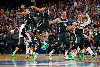 SYRACUSE, NY - MARCH 29:  Alvin Ellis III #3 and Marvin Clark Jr. #0 of the Michigan State Spartans celebrate defeating the Louisville Cardinals 76 to 70 in overtime of the East Regional Final of the 2015 NCAA Men's Basketball Tournament at Carrier Dome o