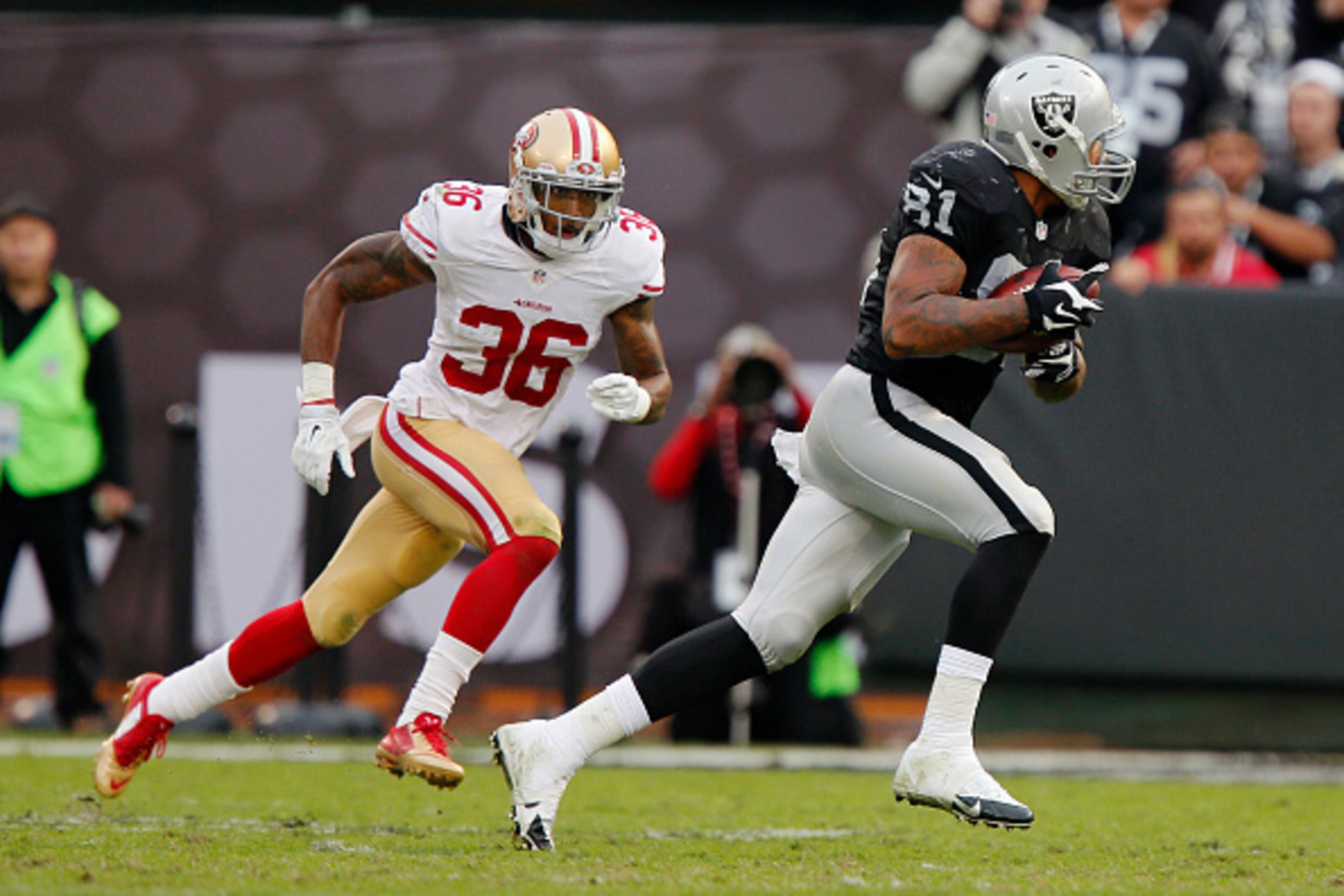 OAKLAND, CA - DECEMBER 7:  Wide receiver Mychal Rivera #81 of the Oakland Raiders takes off with a 27-yard catch against Dontae Johnson #36 of the San Francisco 49ers in the third quarter on December 7, 2014 at O.co Coliseum in Oakland, California.  The R