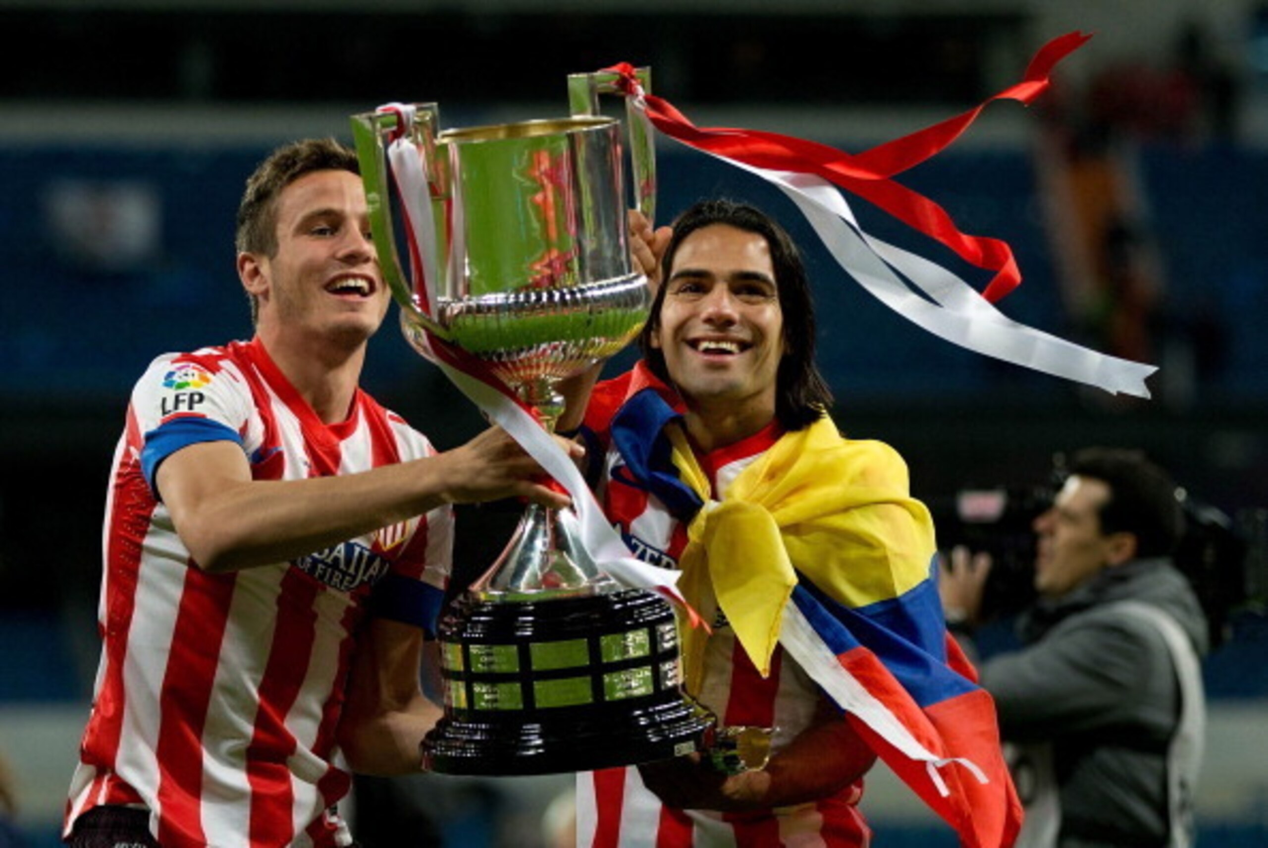 MADRID, SPAIN - MAY 17:  Radamel Falcao (R) of Atletico de Madrid holds the trophy in celebration with his teammate Saul during the Copa del Rey Final match between Real Madrid CF and Club Atletico de Madrid at Estadio Santiago Bernabeu on May 17, 2013 in