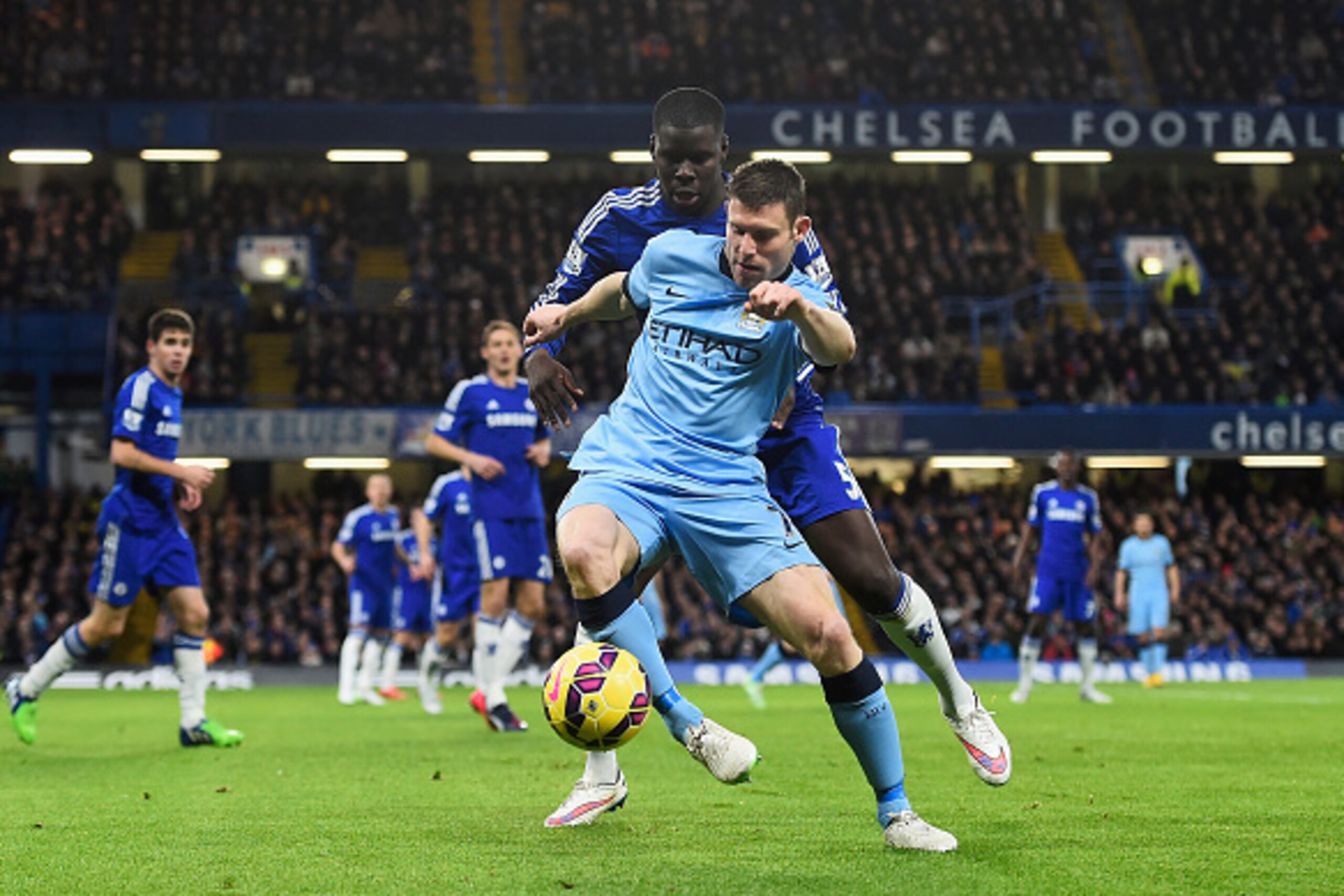 LONDON, ENGLAND - JANUARY 31: James Milner of Manchester City is challenged by Kurt Zouma of Chelsea during the Barclays Premier League match between Chelsea and Manchester City at Stamford Bridge on January 31, 2015 in London, England.  (Photo by Mike He