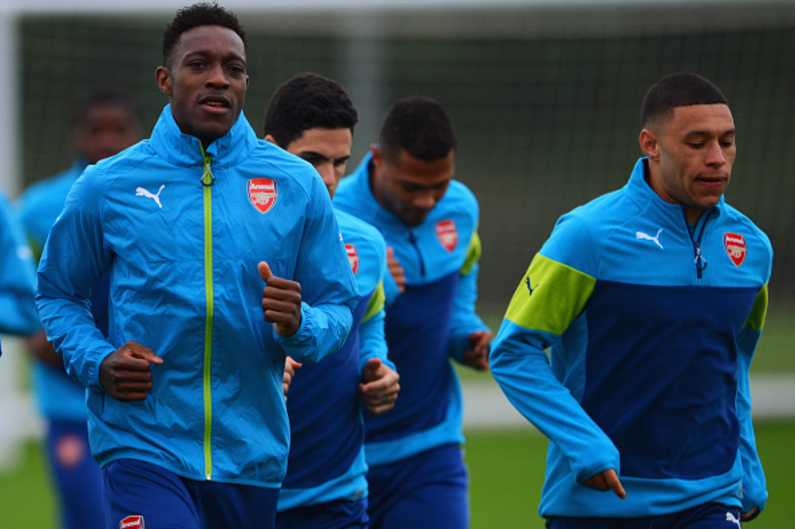 ST ALBANS, ENGLAND - NOVEMBER 03:  Danny Welbeck (L) and Alex Oxlade-Chamberlain (R) warm up during an Arsenal training session ahead of the UEFA Champions League match against RSC Anderlecht at London Colney on November 3, 2014 in St Albans, England.  (P