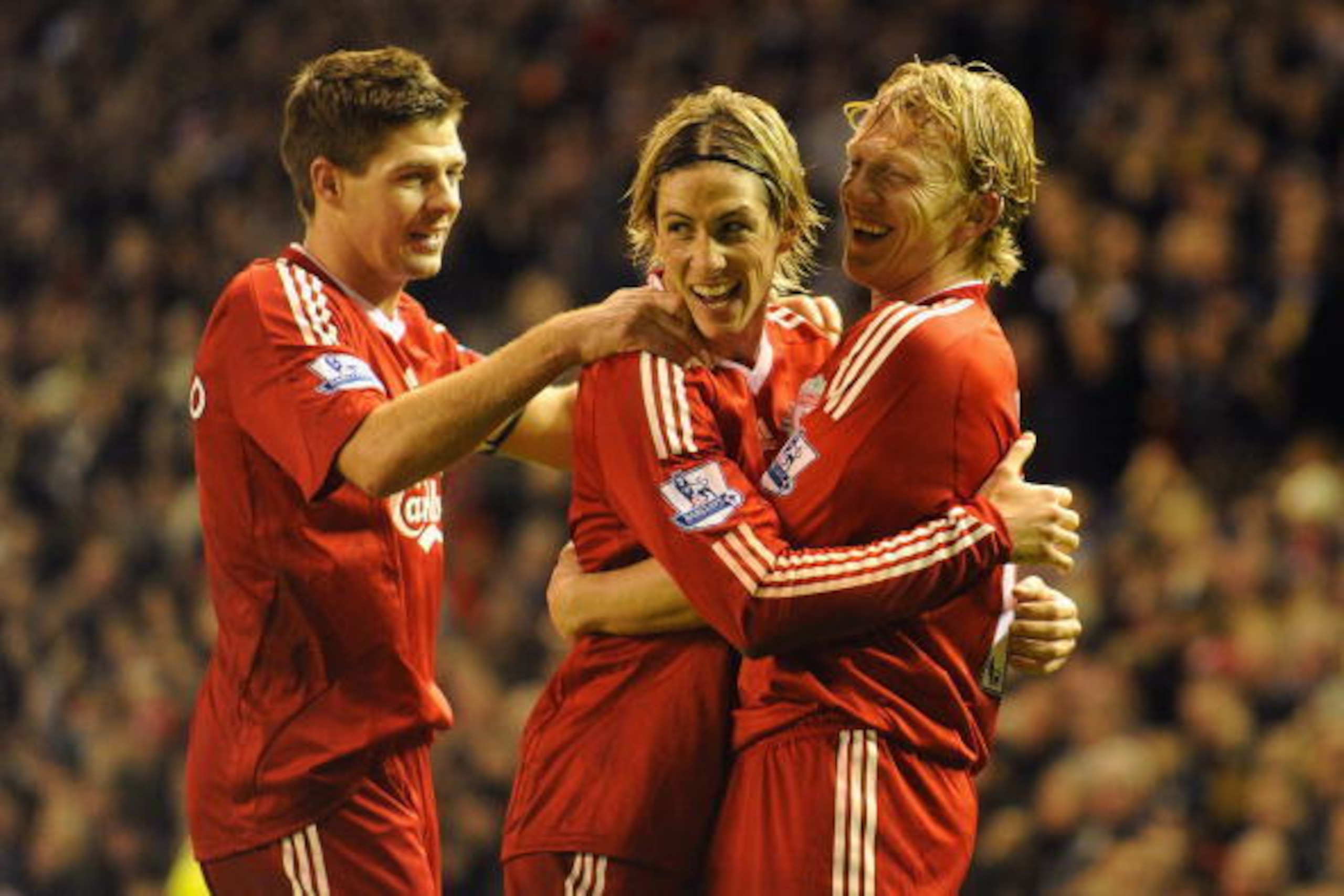 LIVERPOOL, ENGLAND - DECEMBER 13:  Dirk Kuyt (R) of Liverpool celebrates scoring the opening goal with team mates Steven Gerrard (L) and Fernando Torres during the Barclays Premier League match between Liverpool and Arsenal at Anfield on December 13, 2009
