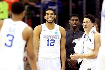 CLEVELAND, OH - MARCH 26: Karl-Anthony Towns #12 and Devin Booker #1 of the Kentucky Wildcats react late in the game against the West Virginia Mountaineers during the Midwest Regional semifinal of the 2015 NCAA Men's Basketball Tournament at Quicken Loans