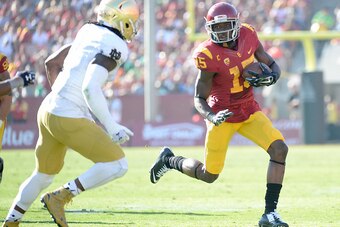 LOS ANGELES, CA - NOVEMBER 29:  Nelson Agholor #15 of the USC Trojans 5at runs after his catch in front of Jaylon Smith #9 of the Notre Dame Fighting Irish Los Angeles Memorial Coliseum on November 29, 2014 in Los Angeles, California.  (Photo by Harry How