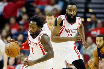 HOUSTON, TX - MARCH 21:   Patrick Beverley #2 of the Houston Rockets takes the basketball up the court in front of James Harden #13  during their game against the Phoenix Sunsat the Toyota Center on March 21, 2015 in Houston, Texas. NOTE TO USER: User exp