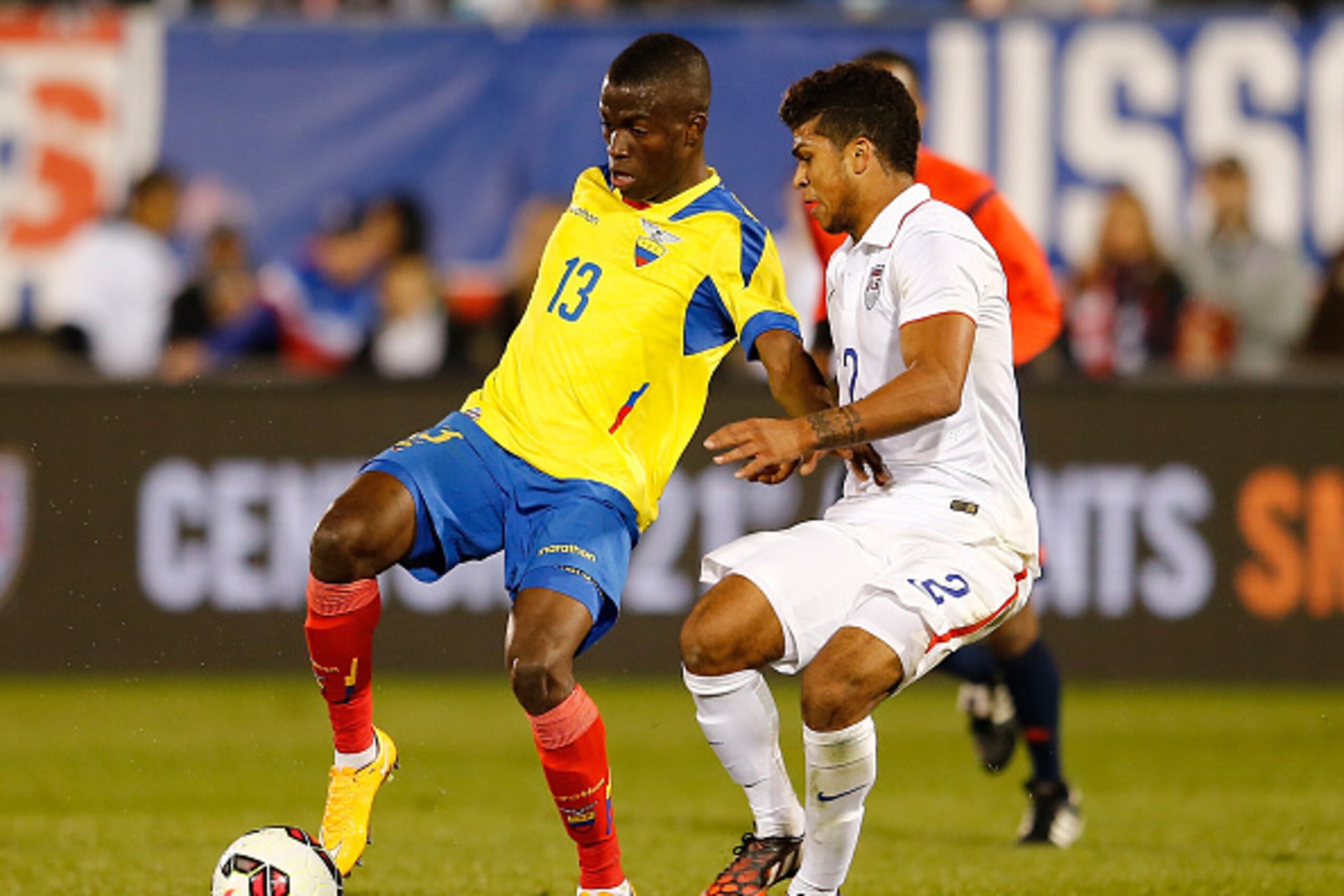 EAST HARTFORD, CT- OCTOBER 10:  Enner Valencia #13 of Ecuador works the ball by DeAndre Yedlin #2 of the United States in the second half during an international friendly at Rentschler Field on October 10, 2014 in East Hartford, Connecticut. (Photo by Jim