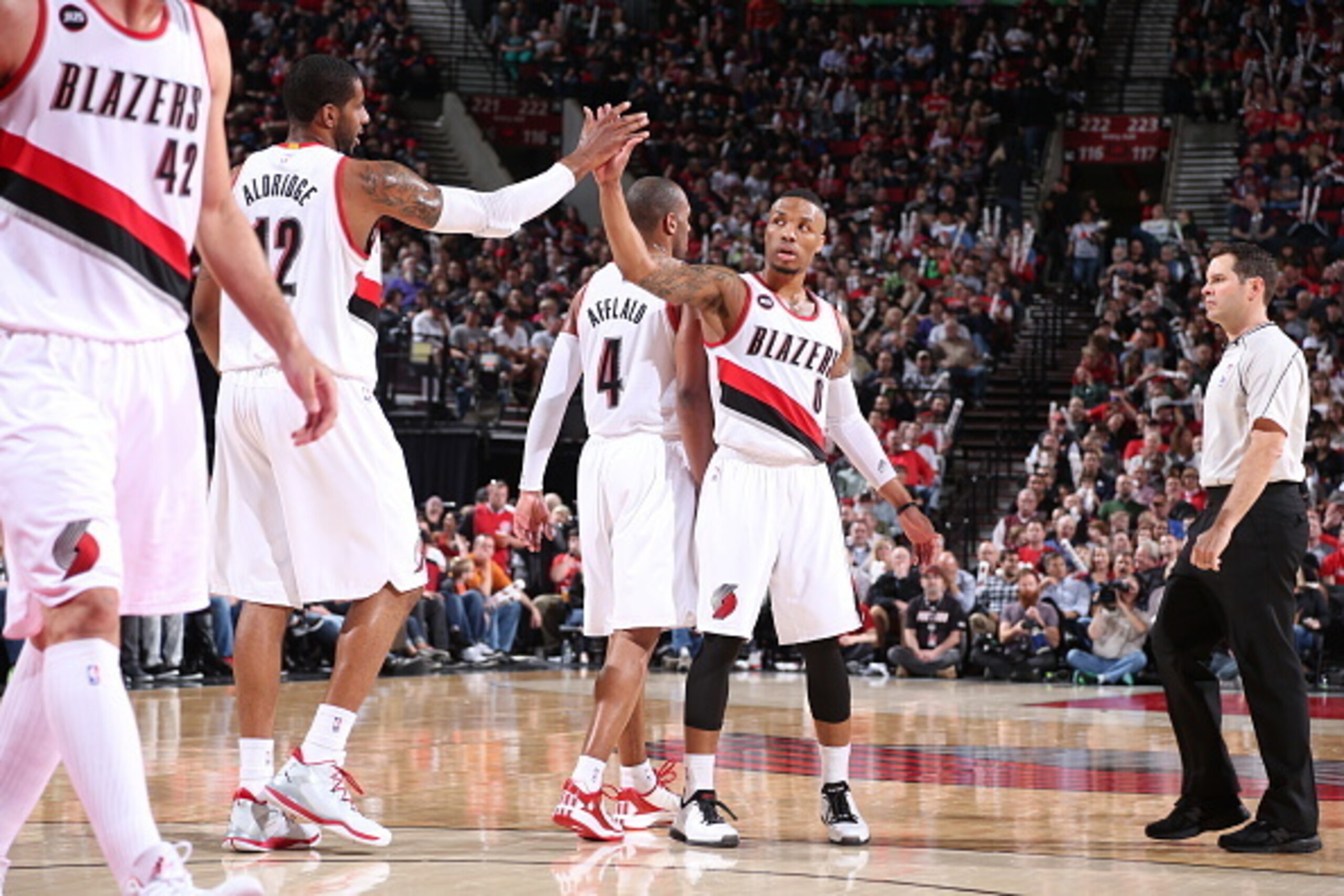 PORTLAND, OR - MARCH 30:  Damian Lillard #0 and LaMarcus Aldridge #12 of the Portland Trail Blazers celebrate during the game against the Phoenix Suns on March 30, 2015 at the Moda Center in Portland, Oregon. NOTE TO USER: User expressly acknowledges and 