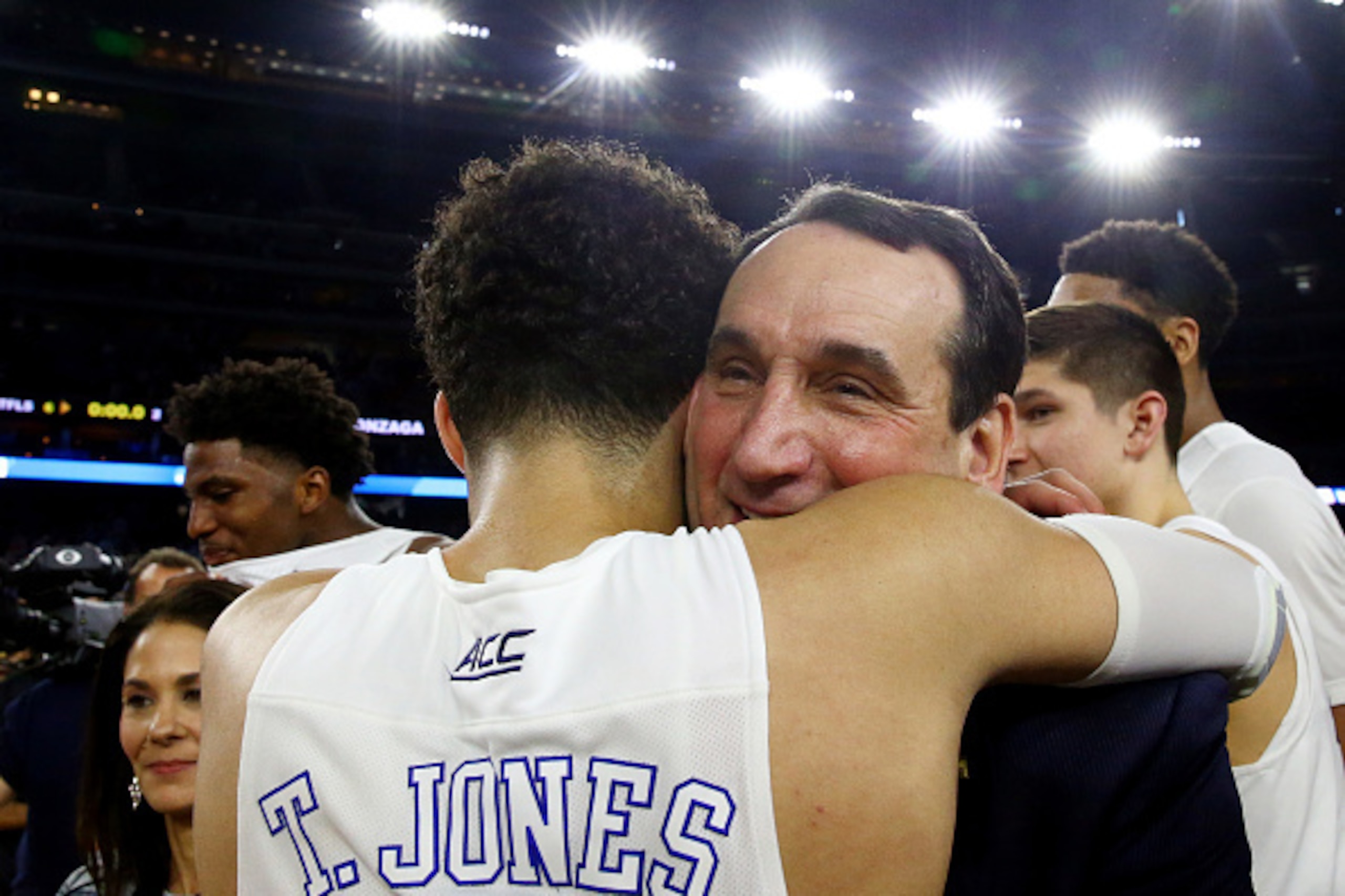 HOUSTON, TX - MARCH 29:  Head coach Mike Krzyzewski hugs Tyus Jones #5 of the Duke Blue Devils after defeating the Gonzaga Bulldogs 66-52 during the South Regional Final of the 2015 NCAA Men's Basketball Tournament at NRG Stadium on March 29, 2015 in Hous