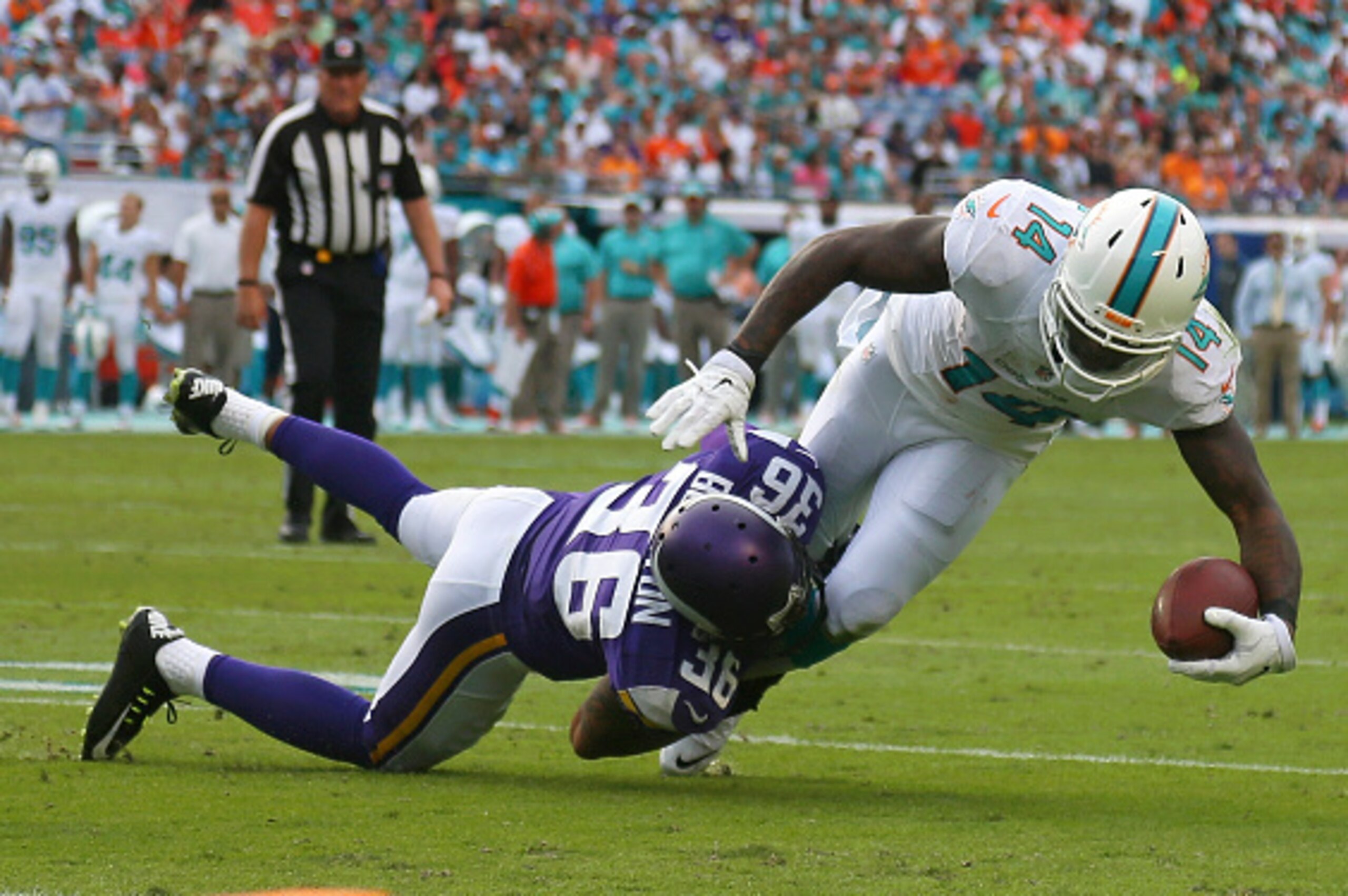 MIAMI GARDENS, FL - DECEMBER 21: Wide receiver Jarvis Landry #14 of the Miami Dolphins is brought down by strong safety Robert Blanton #36 of the Minnesota Vikings during a game at Sun Life Stadium on December 21, 2014 in Miami Gardens, Florida. (Photo MIAMI GARDENS, FL - DECEMBER 21: Wide receiver Jarvis Landry #14 of the Miami Dolphins is brought down by strong safety Robert Blanton #36 of the Minnesota Vikings during a game at Sun Life Stadium on December 21, 2014 in Miami Gardens, Florida. (Photo