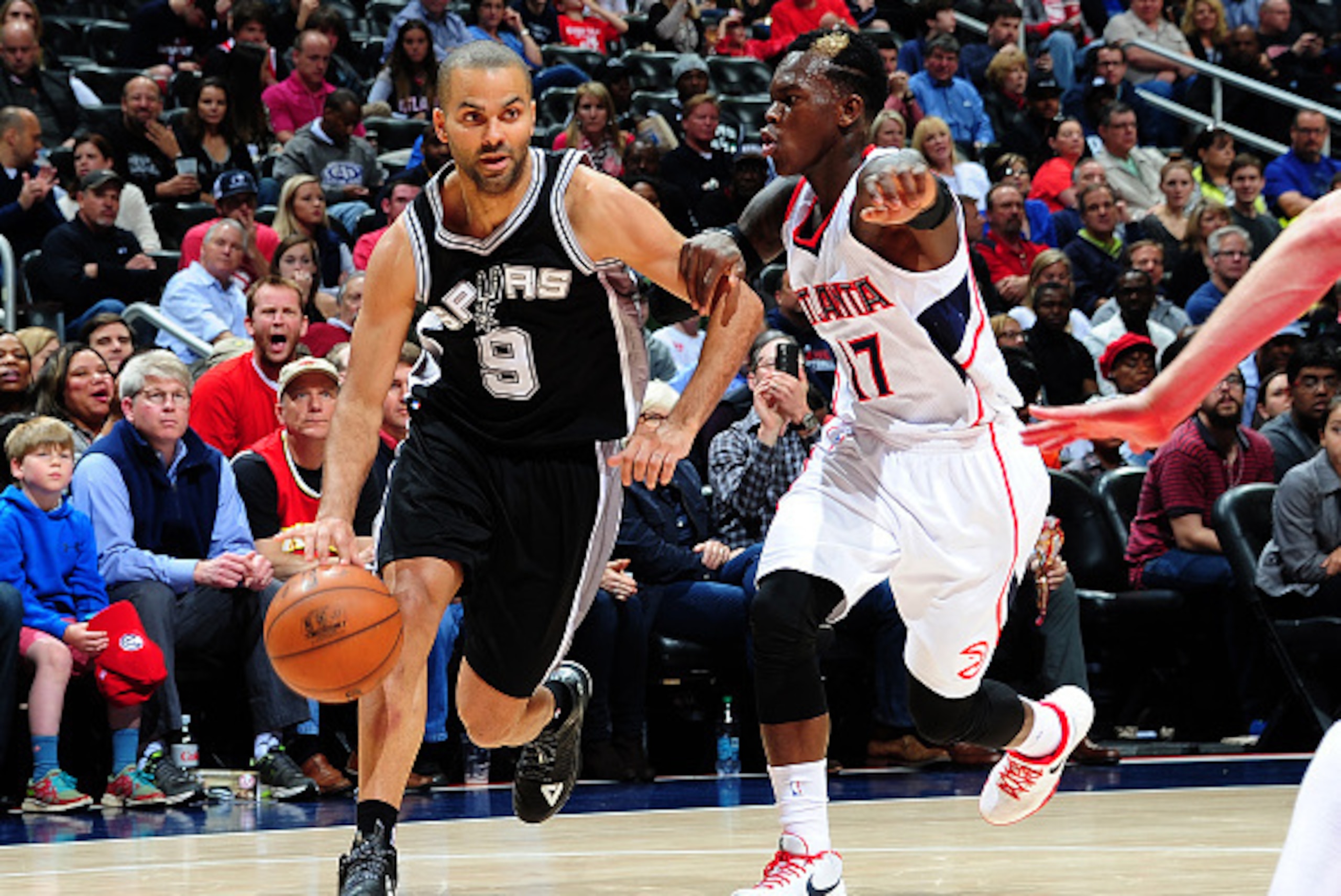 ATLANTA, GA - MARCH 22:  Tony Parker #9 of the San Antonio Spurs handles the ball against Dennis Schroder #17 of the Atlanta Hawks on March 22, 2015 at Philips Arena in Atlanta, Georgia.  NOTE TO USER: User expressly acknowledges and agrees that, by downl