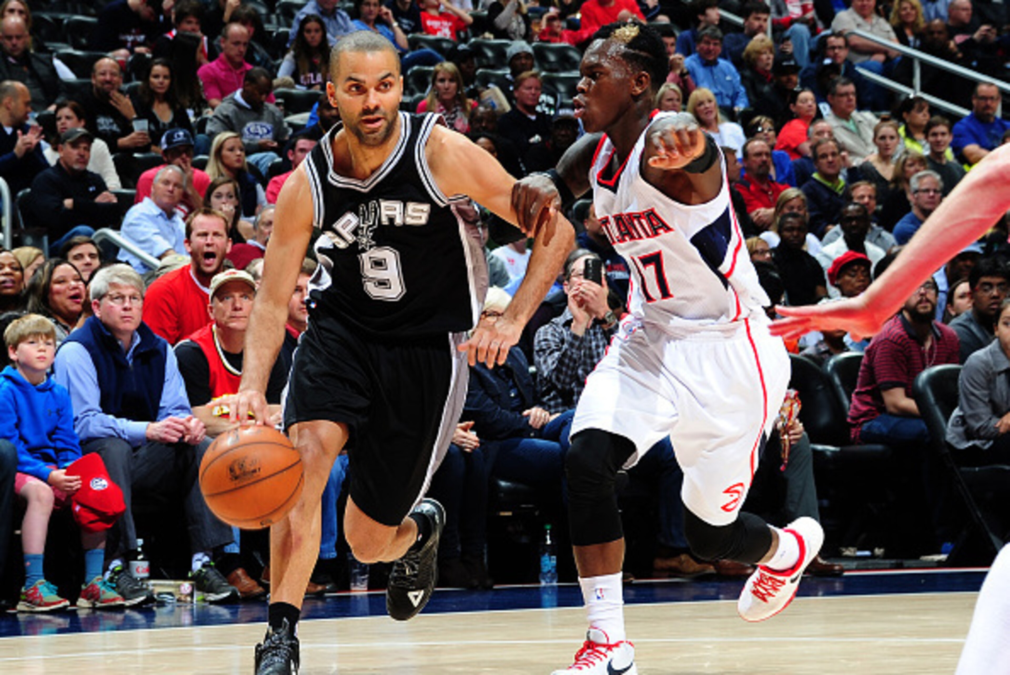 ATLANTA, GA - MARCH 22: Tony Parker #9 of the San Antonio Spurs handles the ball against Dennis Schroder #17 of the Atlanta Hawks on March 22, 2015 at Philips Arena in Atlanta, Georgia. NOTE TO USER: User expressly acknowledges and agrees that, by downl ATLANTA, GA - MARCH 22: Tony Parker #9 of the San Antonio Spurs handles the ball against Dennis Schroder #17 of the Atlanta Hawks on March 22, 2015 at Philips Arena in Atlanta, Georgia. NOTE TO USER: User expressly acknowledges and agrees that, by downl