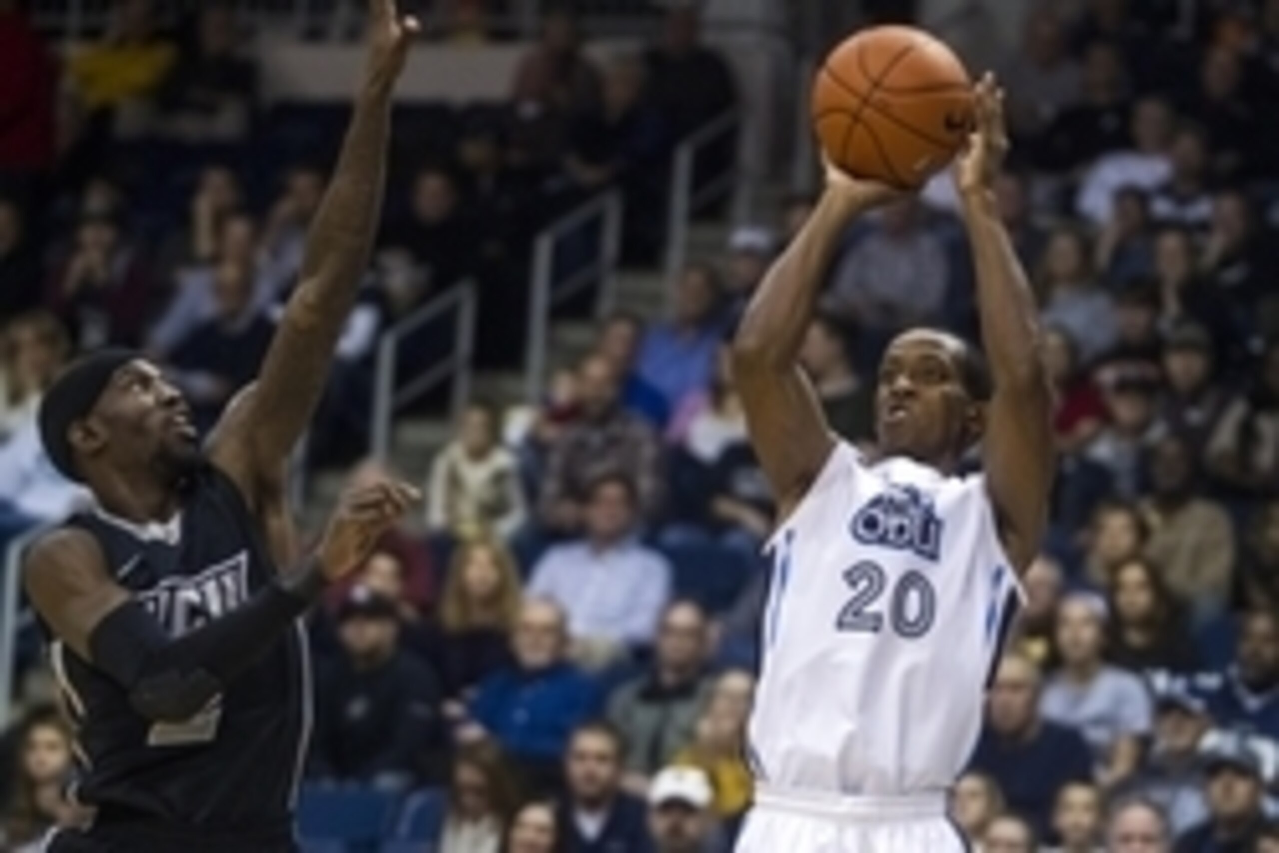 Nov 29, 2014; Norfolk, VA, USA; Old Dominion Monarchs guard Trey Freeman (20) shoots the ball over Virginia Commonwealth Rams guard Briante Weber (2) during the first half at Constant Convocation Center. Mandatory Credit: Peter Casey-USA TODAY Sports
