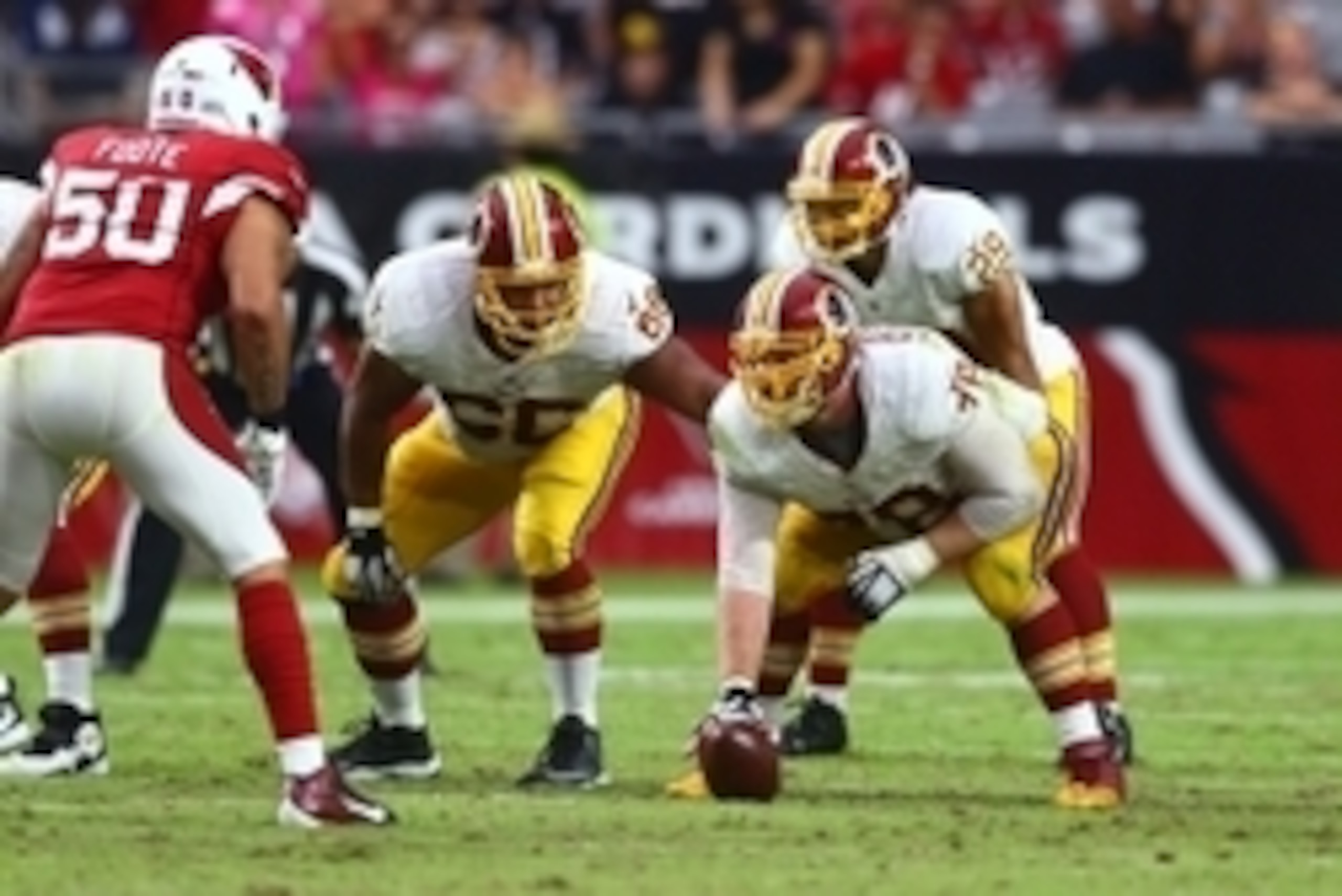Oct 12, 2014; Glendale, AZ, USA; Washington Redskins offensive guard Chris Chester (66) looks on as center Kory Lichtensteiger (78) prepares to snap the ball against the Arizona Cardinals at University of Phoenix Stadium. The Cardinals defeated the Redski