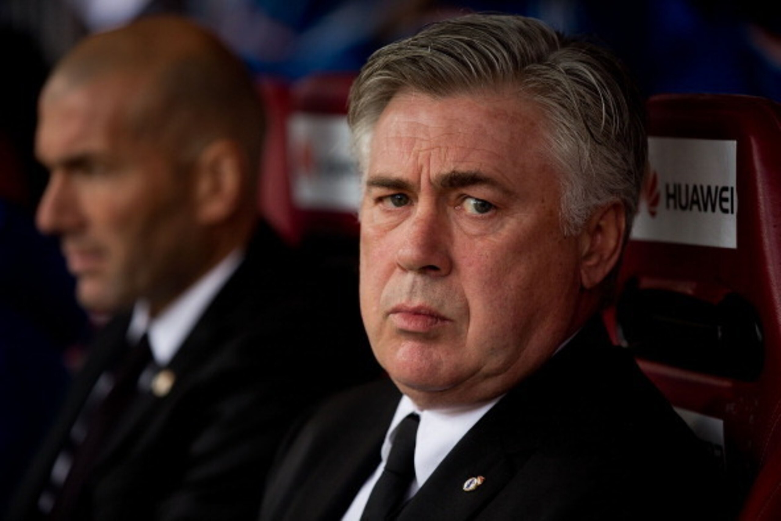 MADRID, SPAIN - MARCH 02: Head coach Carlo Ancelotti (R) of Real Madrid CF looks on sitted on the bench close to assistant coach Zinedine Zidane (L) prior to start the La Liga match between Club Atletico de Madrid and Real Madrid CF at Vicente Calderon St