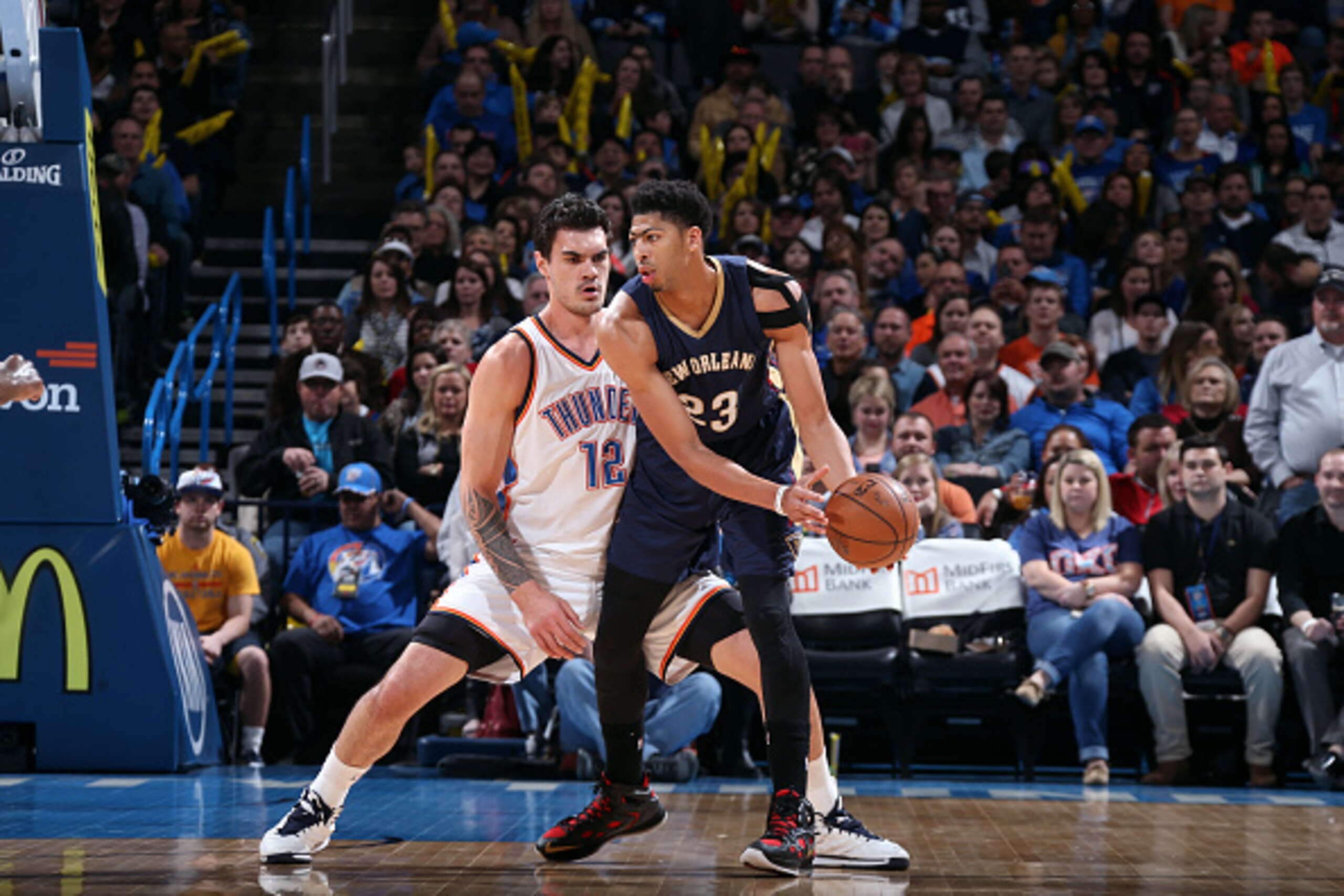 OKLAHOMA CITY, OK- FEBRUARY 6: Anthony Davis #23 of the New Orleans Pelicans handles the ball against Steven Adams #12 of the Oklahoma City Thunder on February 6, 2015 at Chesapeake Energy Arena in Oklahoma City, OK. NOTE TO USER: User expressly acknowled