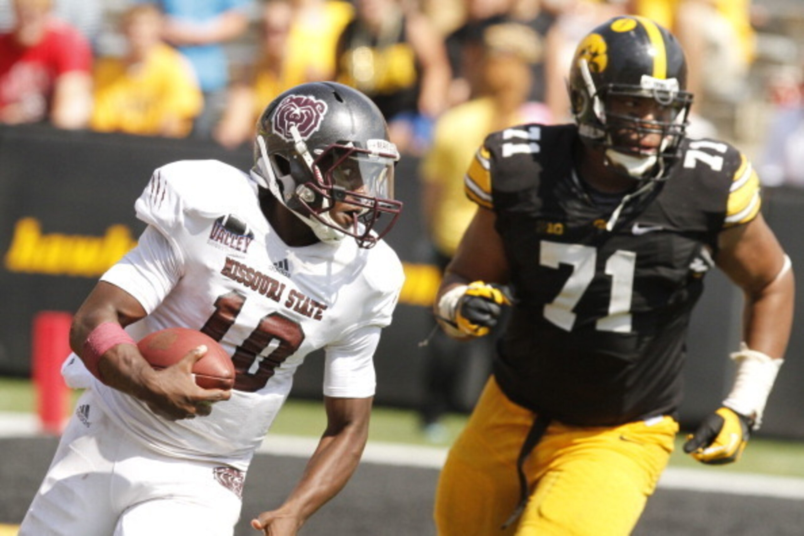 IOWA CITY, IOWA- SEPTEMBER 7:  Quarterback Kierra Harris #10 of the Missouri State Bears is chased by defensive lineman Carl Davis #71 of the Iowa Hawkeyes during the fourth quarter on September 7, 2013 at Kinnick Stadium in Iowa City, Iowa. Iowa won 28-1