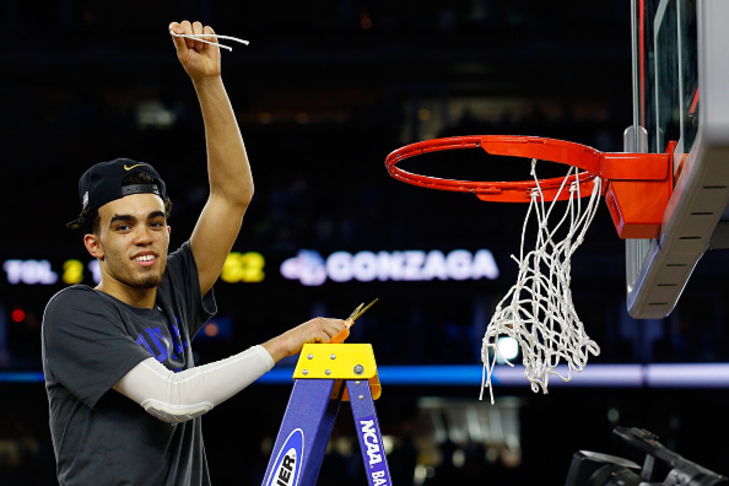 HOUSTON, TX - MARCH 29: Tyus Jones #5 of the Duke Blue Devils cuts the net after defeating the Gonzaga Bulldogs 66-52 in the South Regional Final of the 2015 NCAA Men's Basketball Tournament at NRG Stadium on March 29, 2015 in Houston, Texas. (Photo by HOUSTON, TX - MARCH 29: Tyus Jones #5 of the Duke Blue Devils cuts the net after defeating the Gonzaga Bulldogs 66-52 in the South Regional Final of the 2015 NCAA Men's Basketball Tournament at NRG Stadium on March 29, 2015 in Houston, Texas. (Photo by