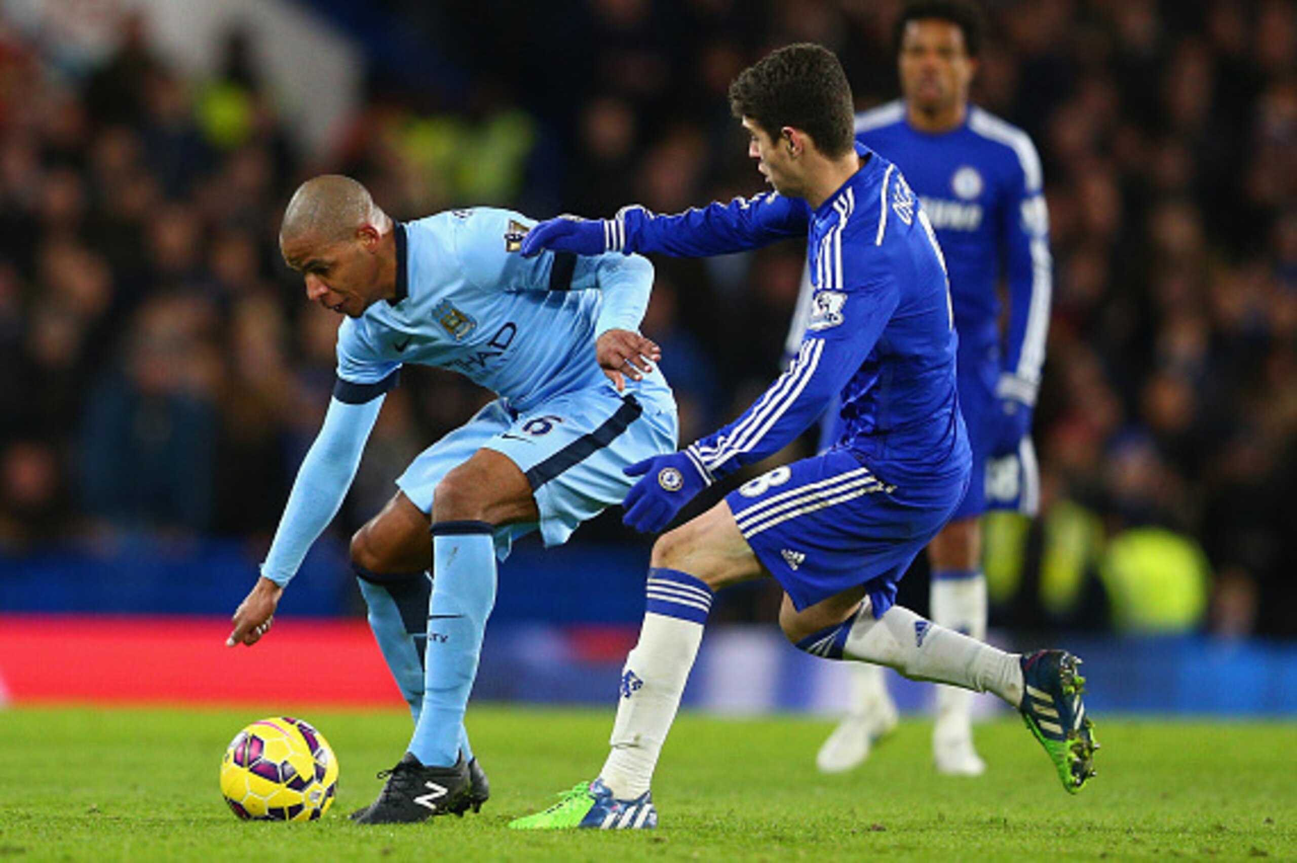 LONDON, ENGLAND - JANUARY 31:  Fernando of Manchester City and Oscar of Chelsea battle for the ball during the Barclays Premier League match between Chelsea and Manchester City at Stamford Bridge on January 31, 2015 in London, England.  (Photo by Clive Ma