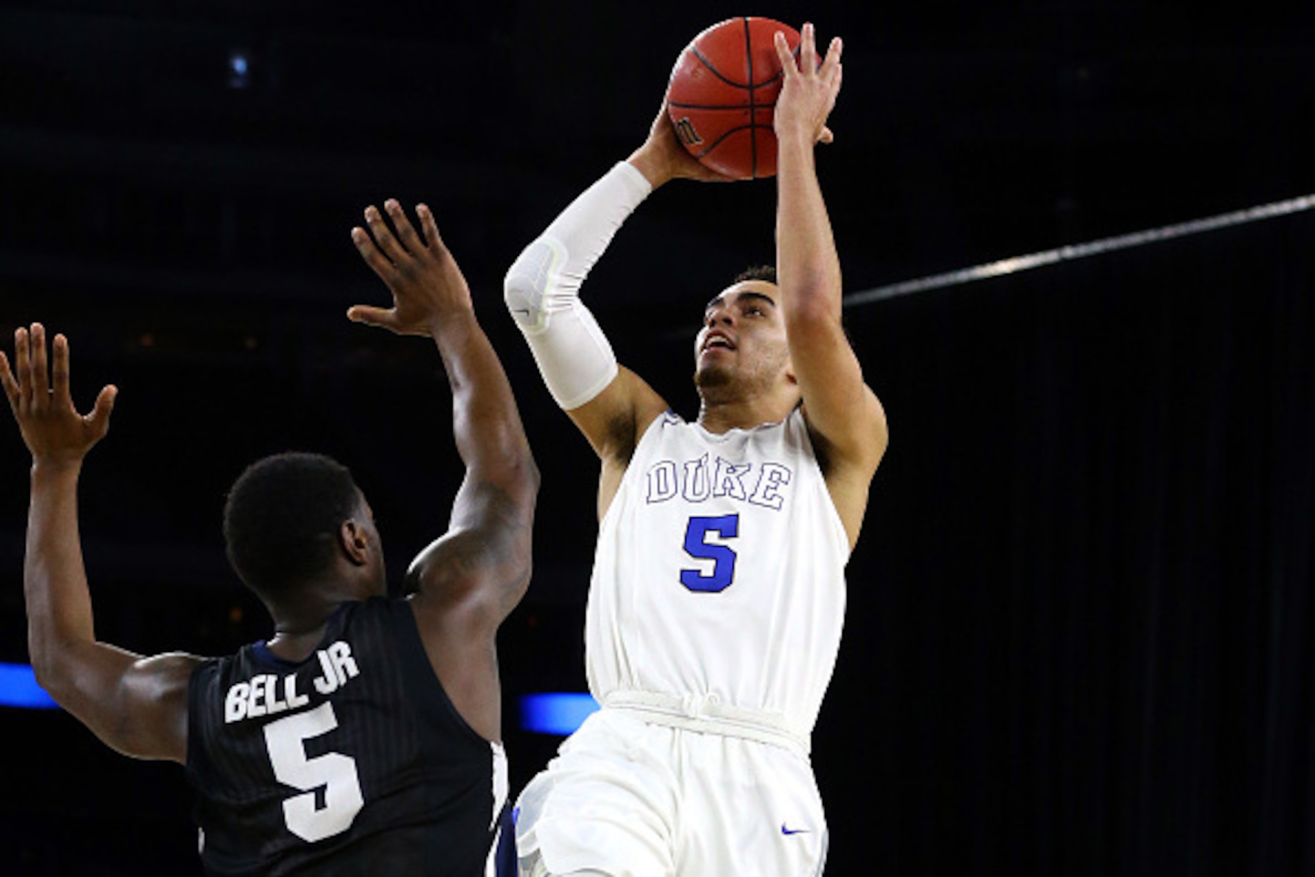 HOUSTON, TX - MARCH 29: Tyus Jones #5 of the Duke Blue Devils takes a shot over Gary Bell Jr. #5 of the Gonzaga Bulldogs in the first half during the South Regional Final of the 2015 NCAA Men's Basketball Tournament at NRG Stadium on March 29, 2015 in Hou