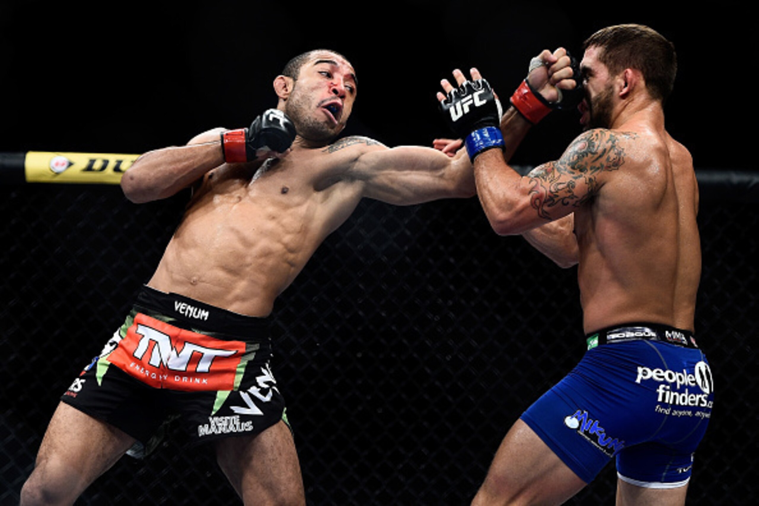 RIO DE JANEIRO, BRAZIL - OCTOBER 25: Jose Aldo of Brazil punches Chad Mendes of the United States in their featherweight championship bout during the UFC 179 event at Maracanazinho on October 25, 2014 in Rio de Janeiro, Brazil. (Photo by Buda Mendes/Getty