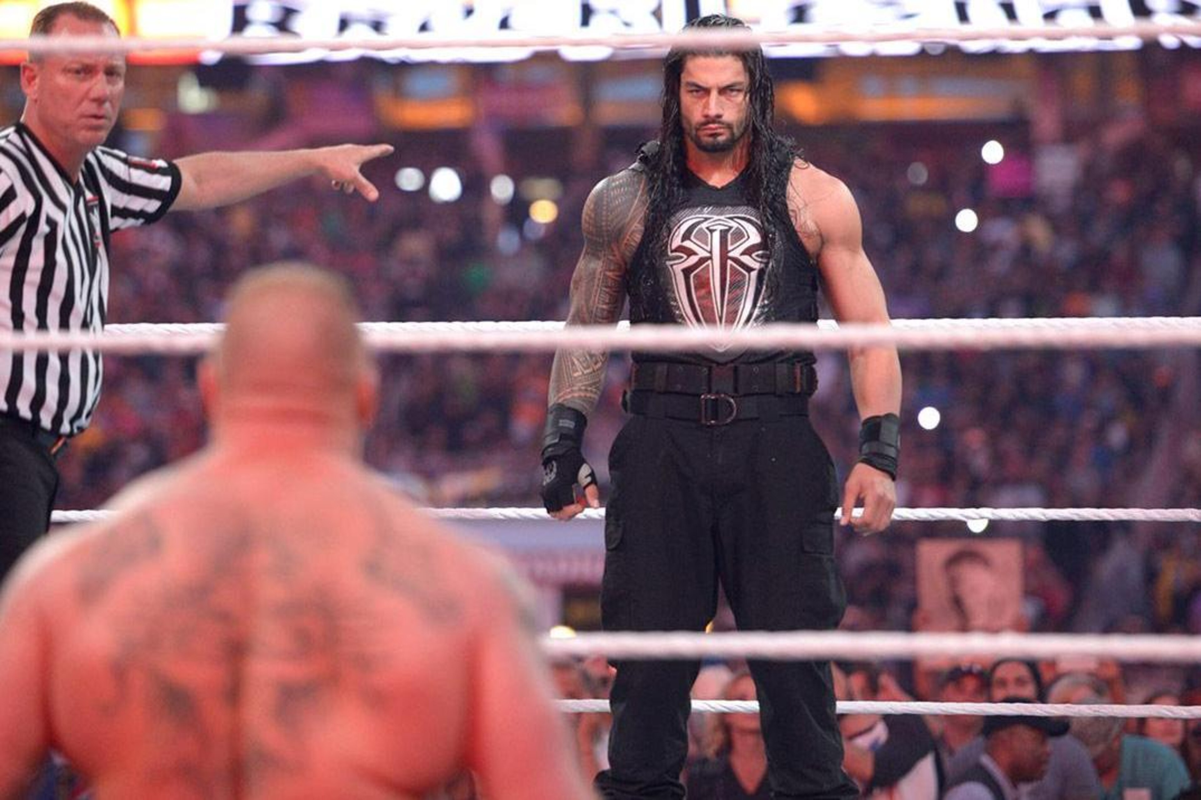 Roman Reigns stares down Brock Lesnar.