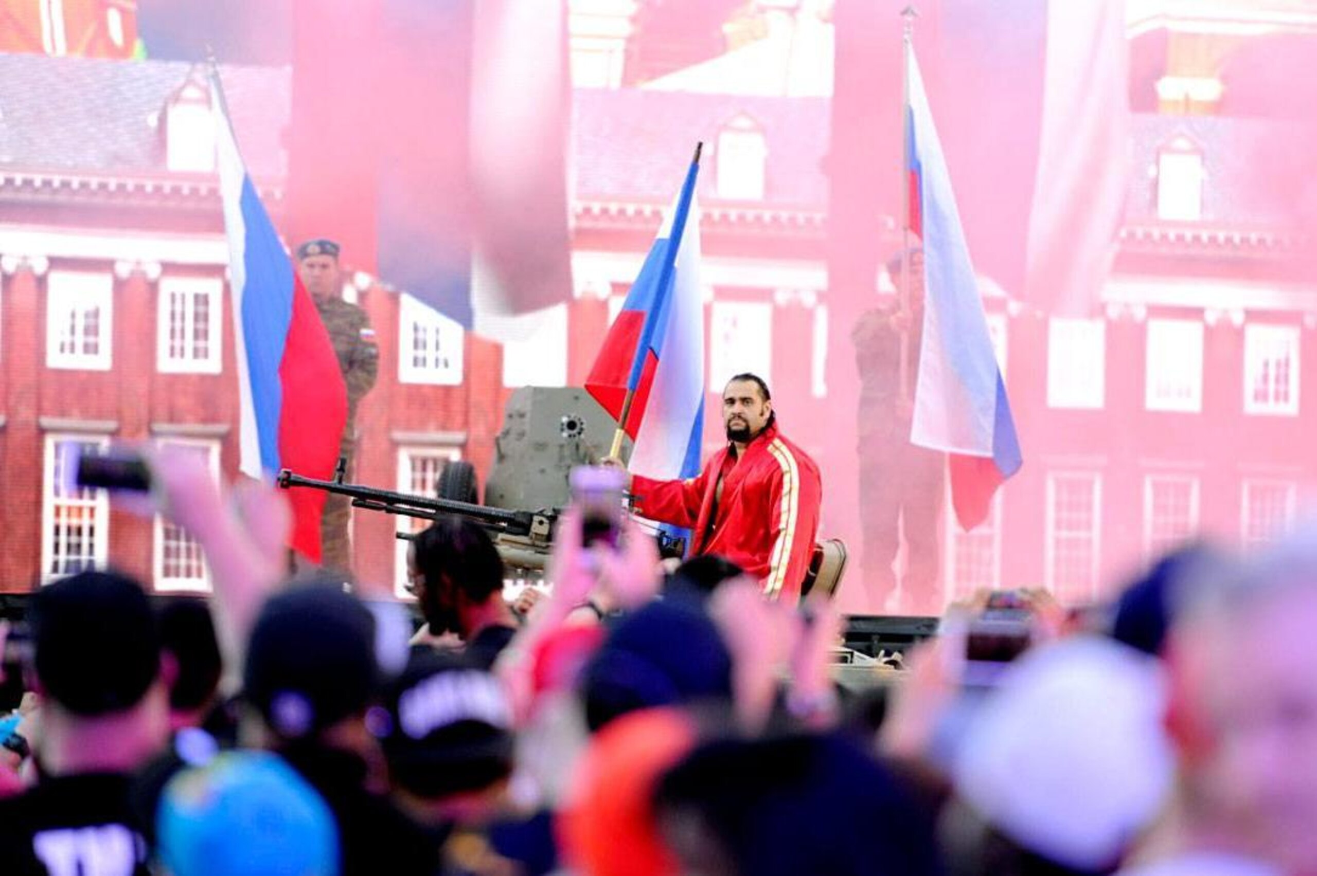 Rusev rides a tank en route to the ring.